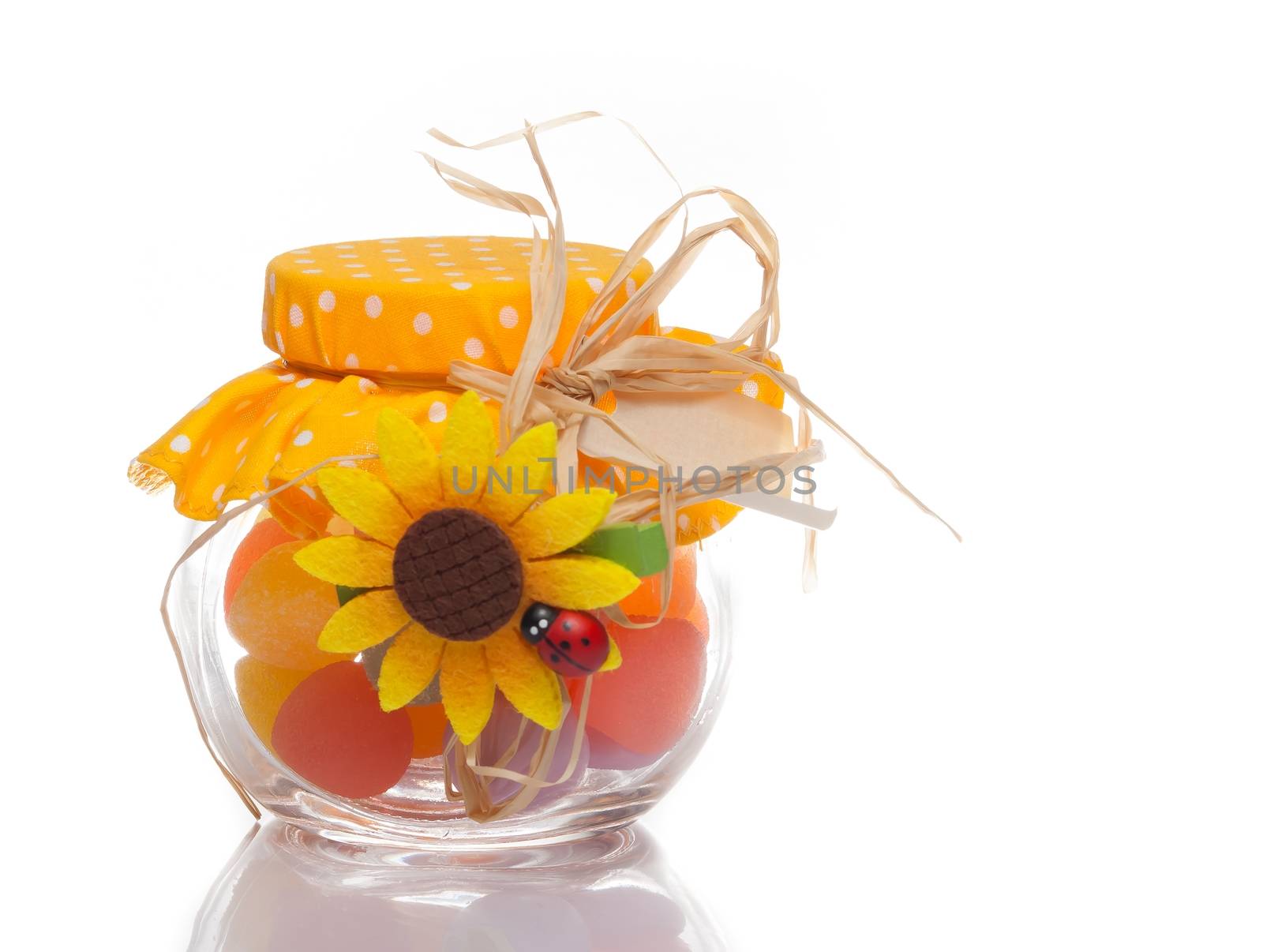 colourful multi coloured candy in a decorative glass jar for a festive gift on white background