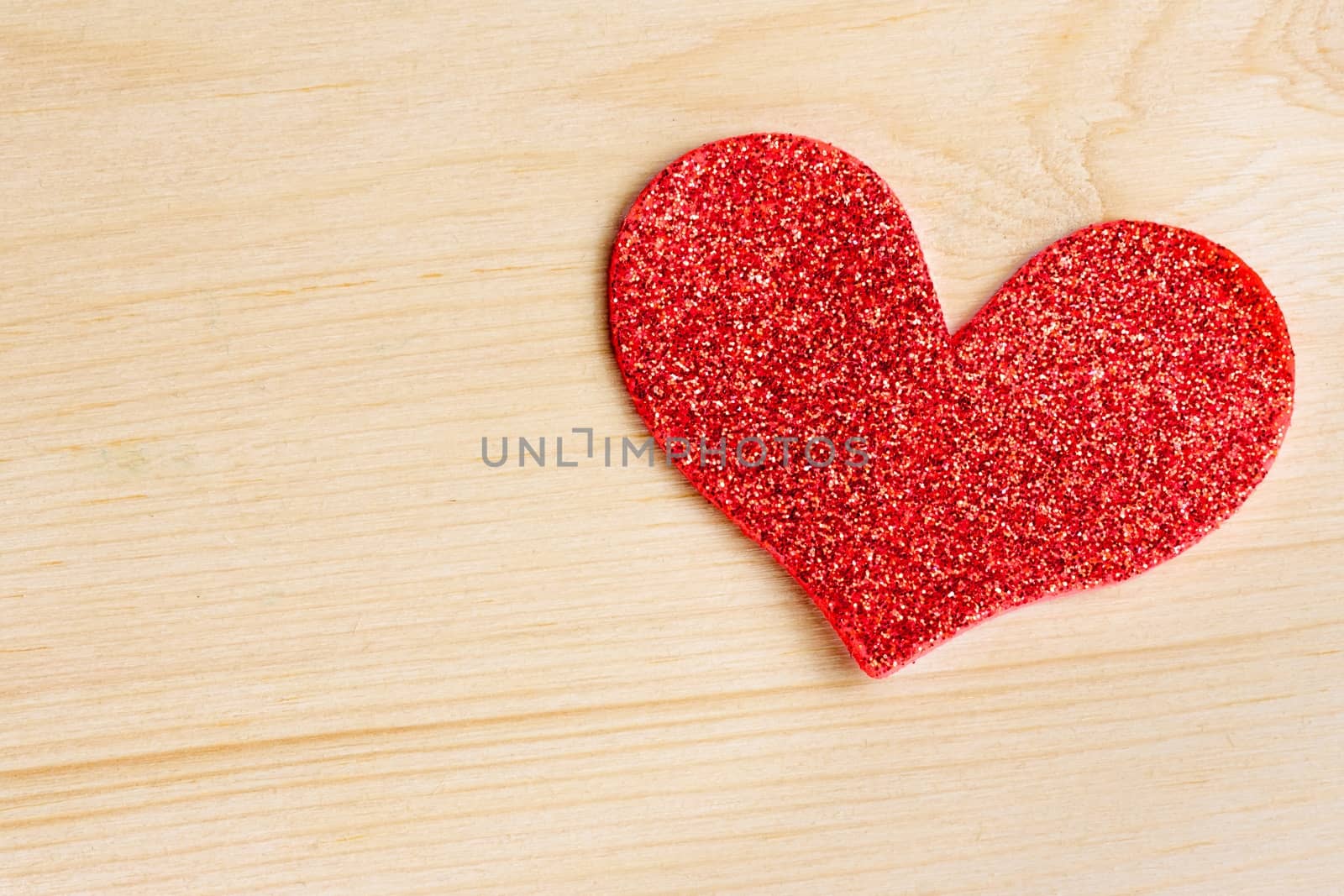 one decorative red heart on wood background with space for text, concept of love