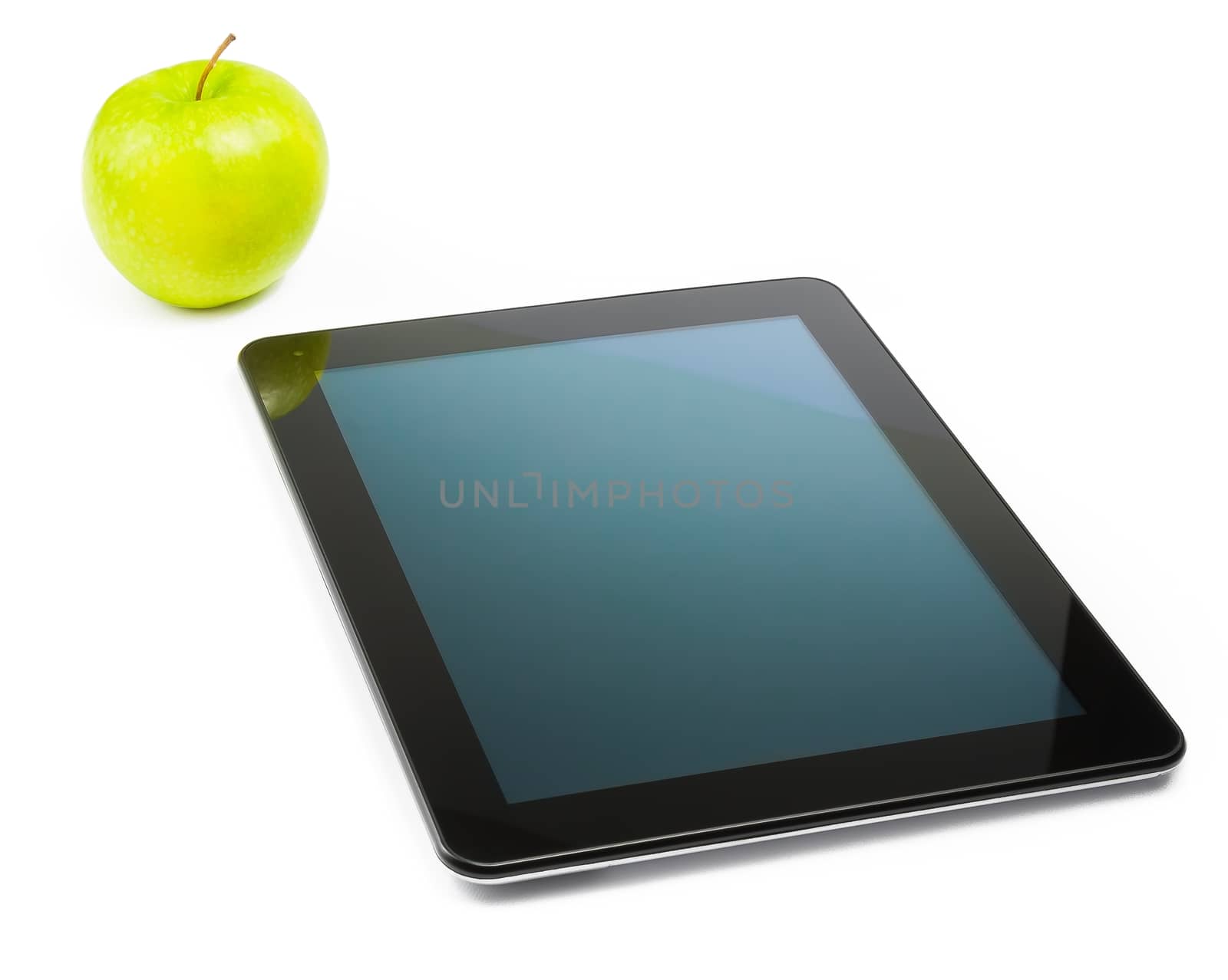 digital tablet pc near green apple on white background by donfiore