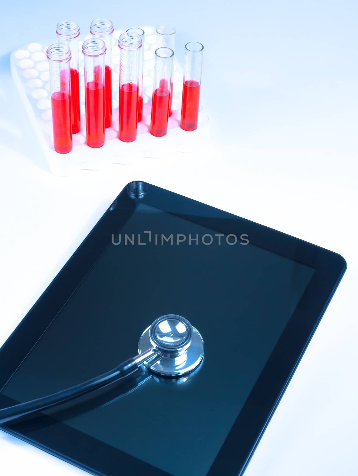 top of view of medical stethoscope on modern digital tablet pc in laboratory. Concept of medical or research theme