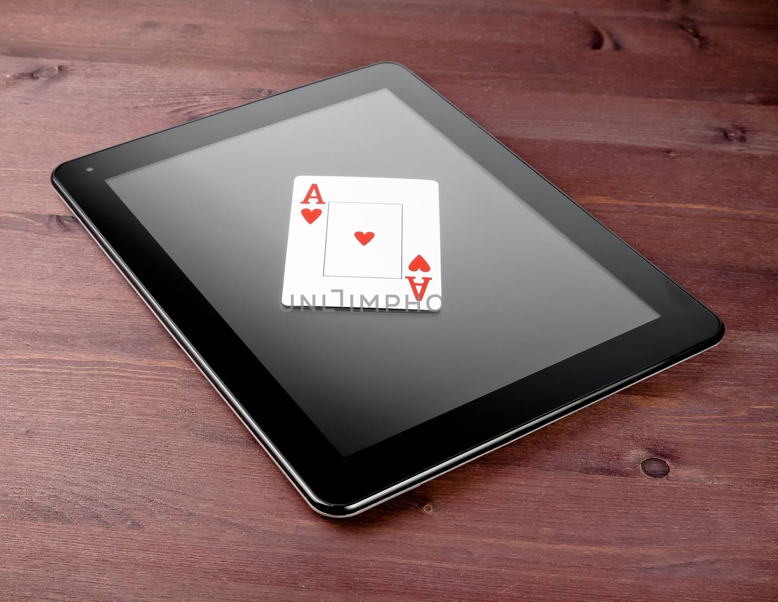 single poker card on digital tablet pc on old wood table, concept of  texas poker online