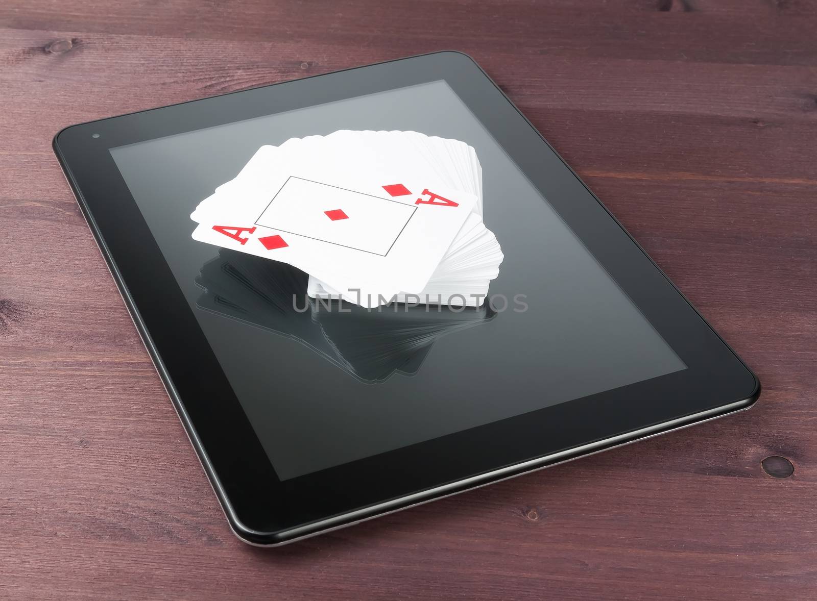 deck of playing cards on digital tablet pc, concept of texas poker online by donfiore