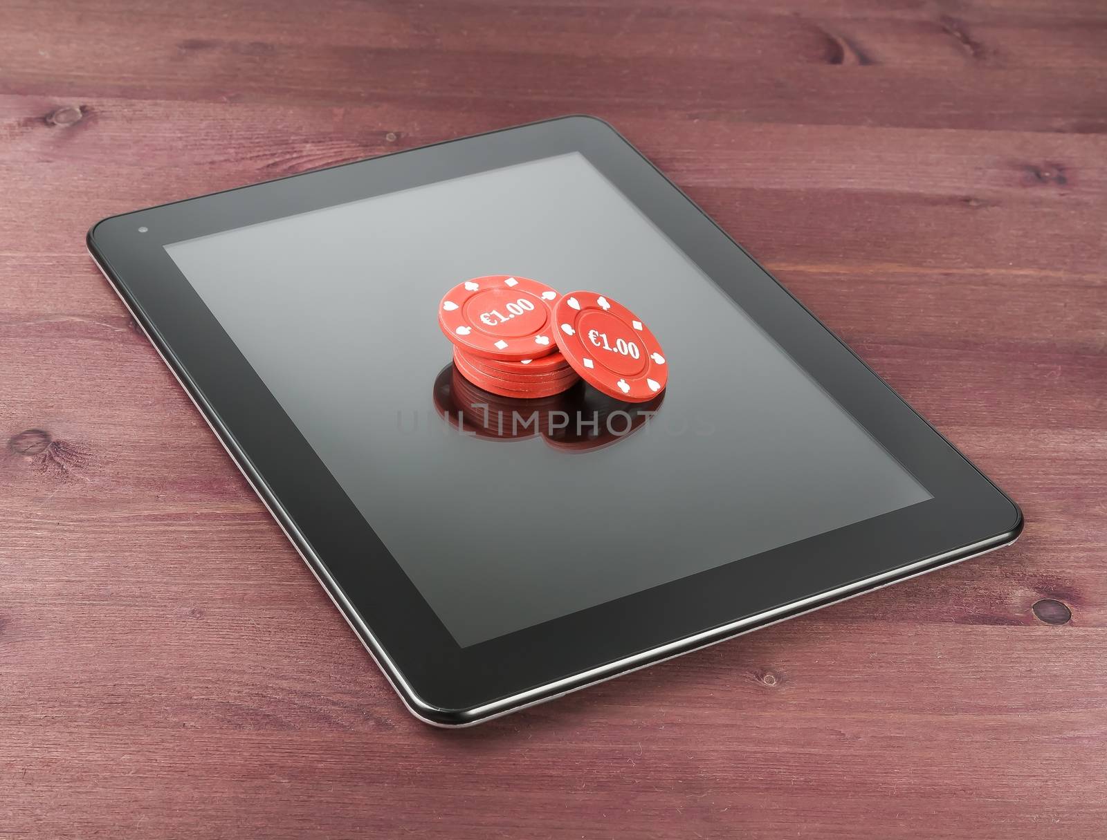 red gambling chips on digital tablet pc, concept of texas game online by donfiore