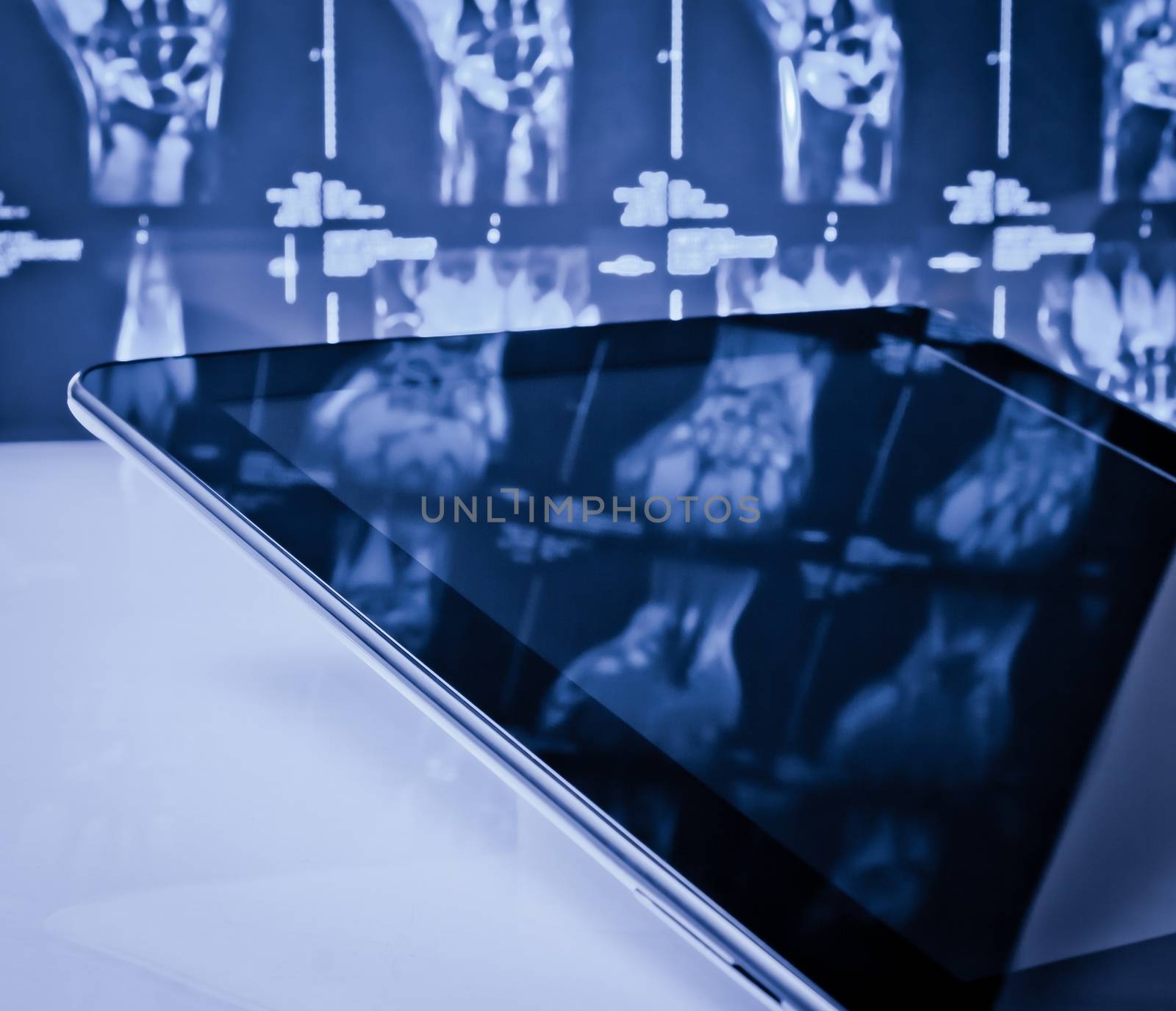 modern digital tablet pc in laboratory on x-ray images background by donfiore