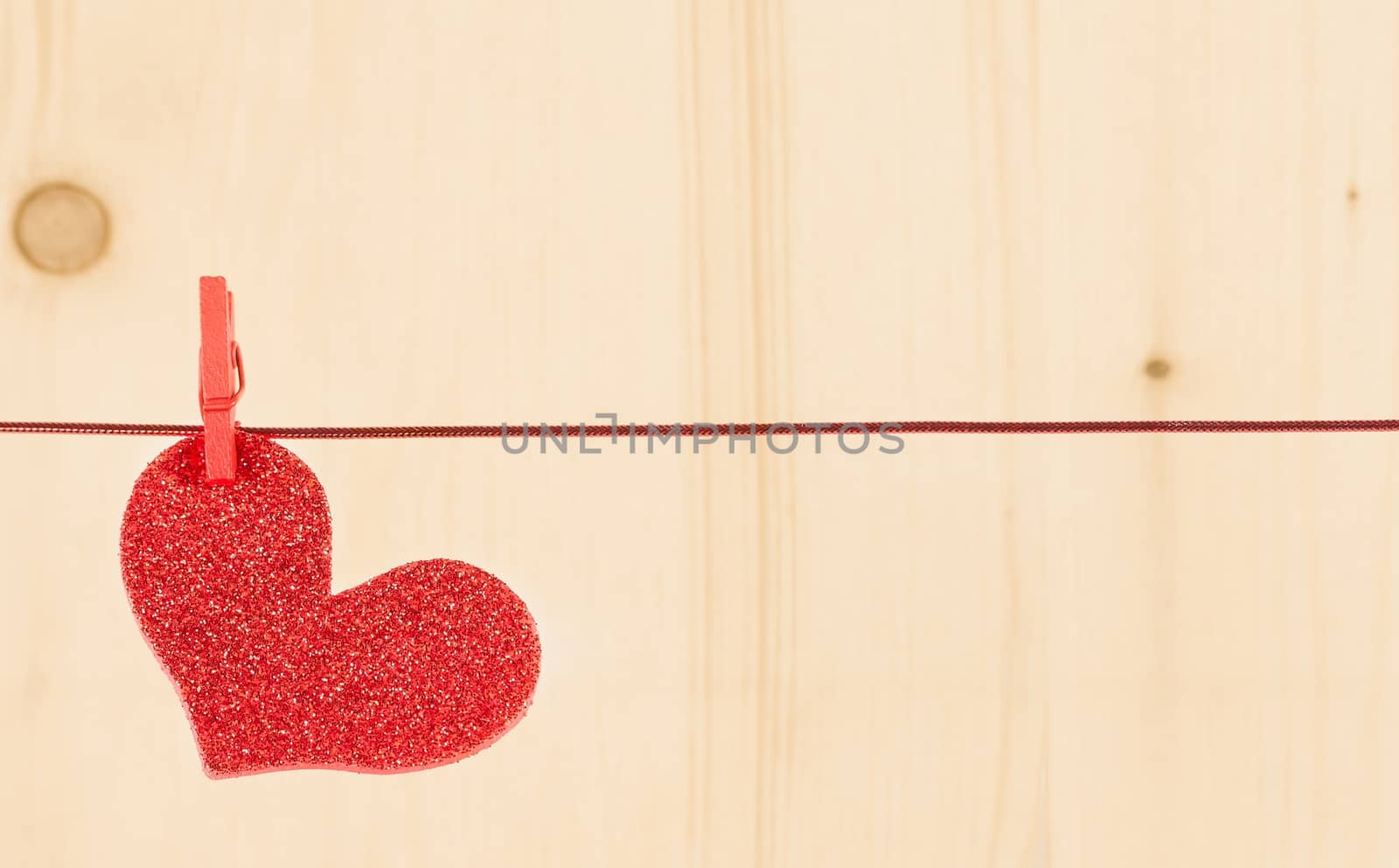 one decorative red heart hanging on wood background, concept of valentine day by donfiore