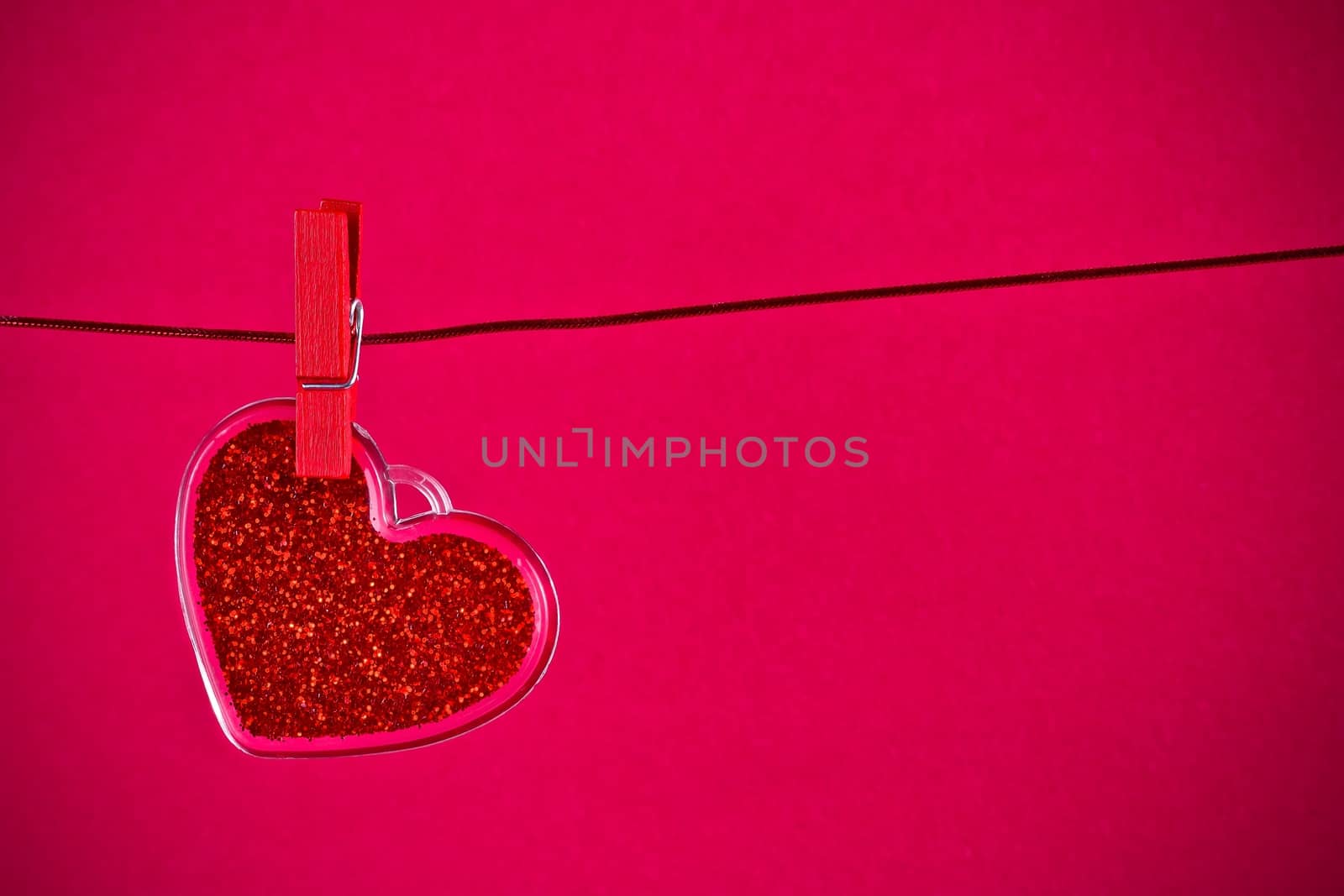 valentine day series, decorative red heart hanging on red background with space for text