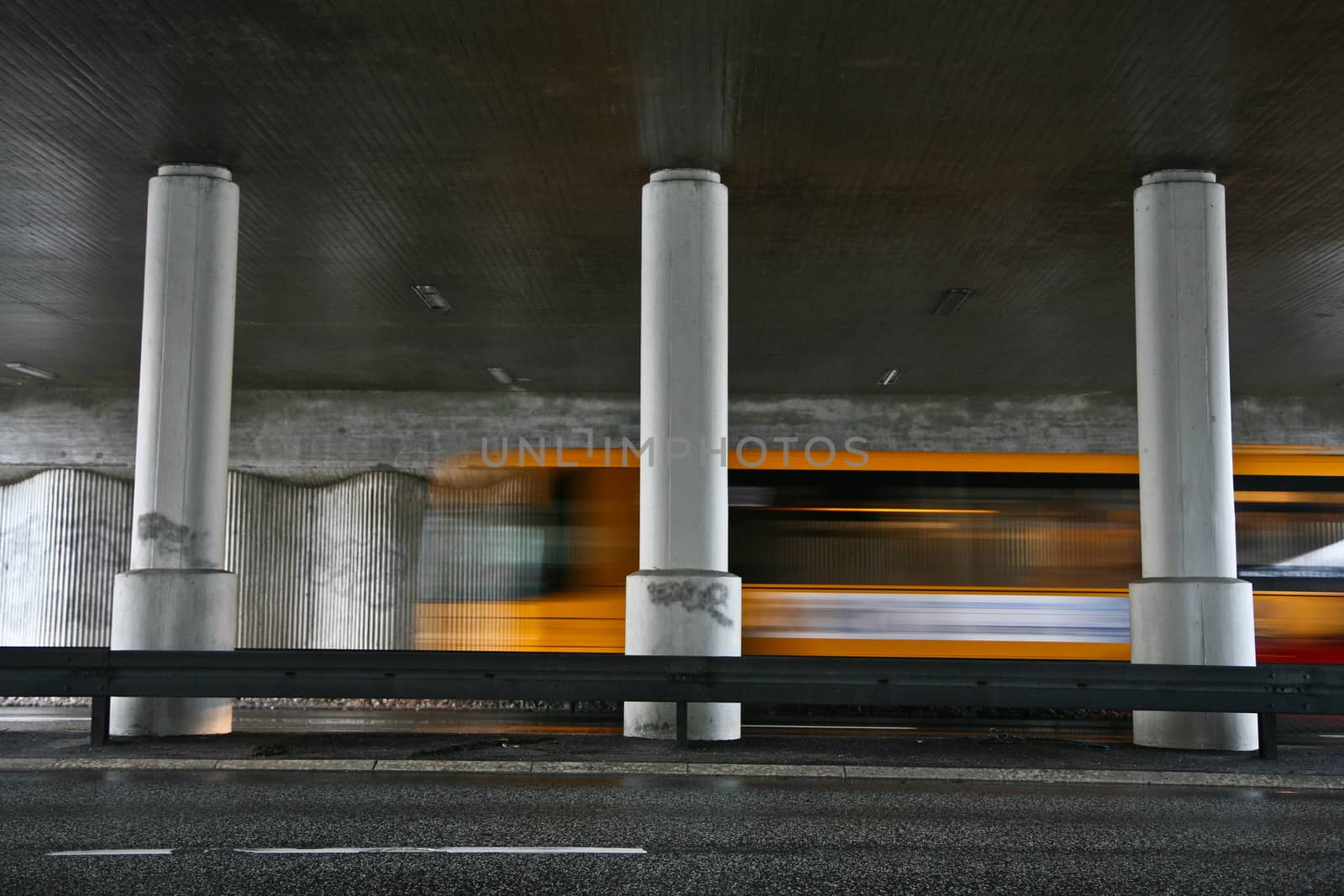 Traffic under the bridge and fast vehicles passing by