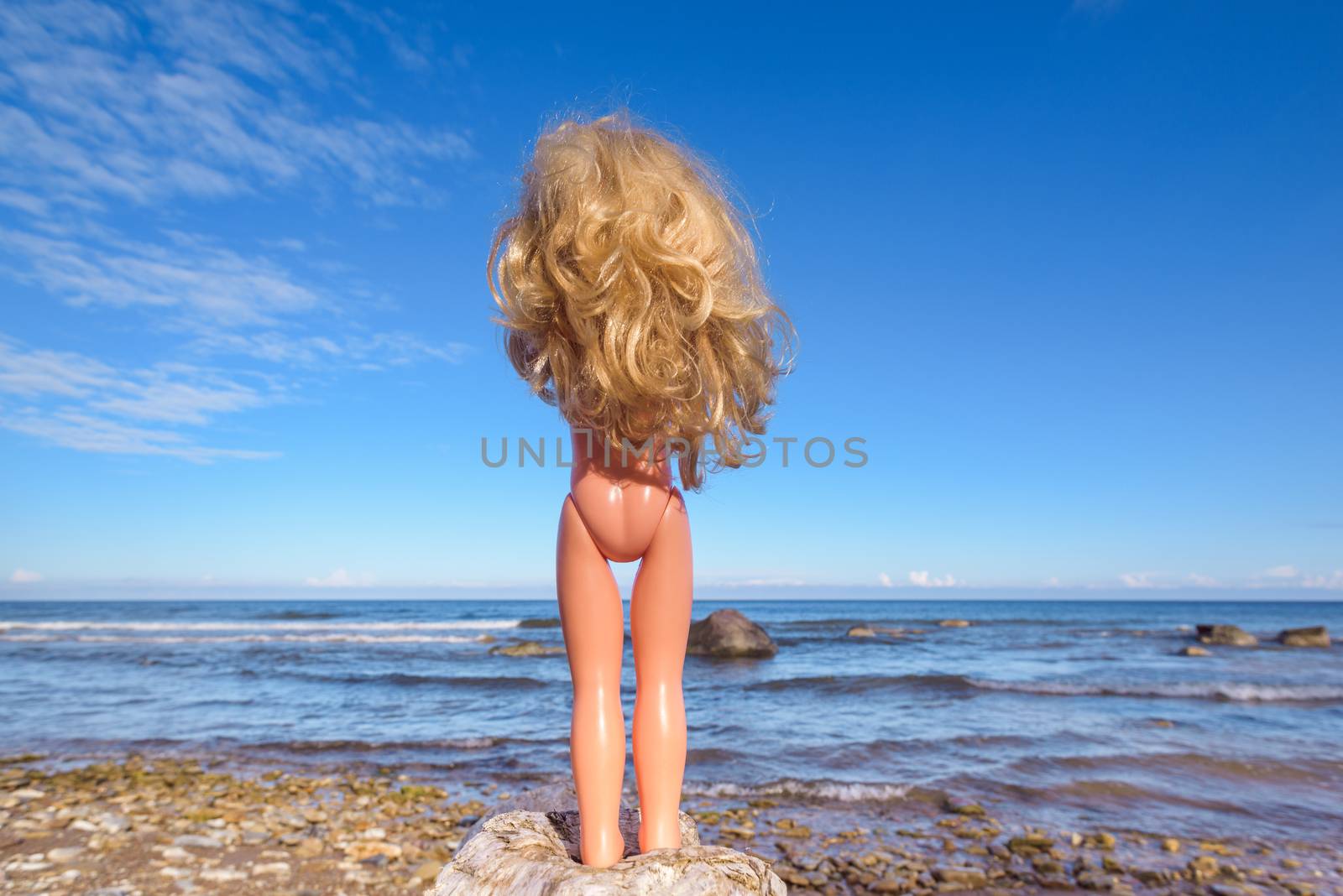 Plastic baby doll on the seashore