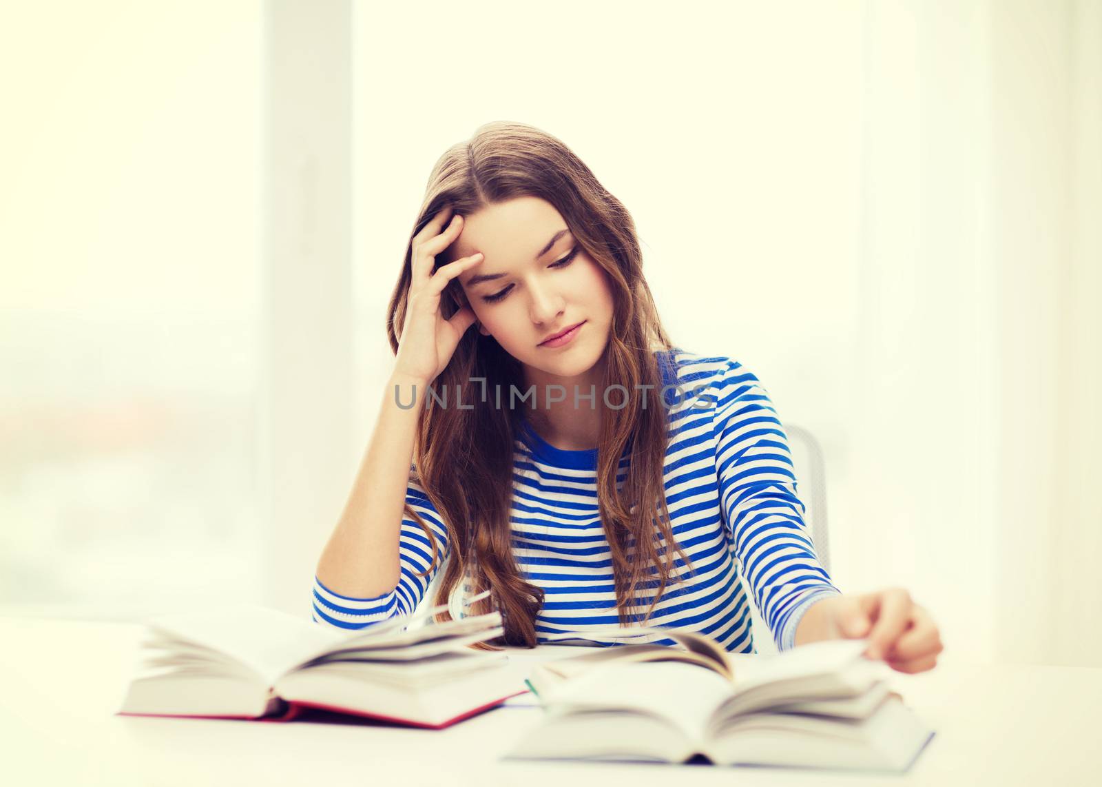 education and home concept - stressed student girl with books