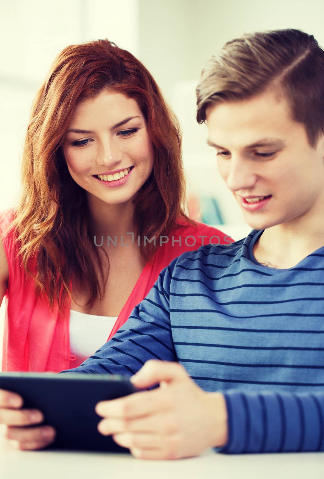 education, technology and internet concept - smiling students with tablet pc computers at school