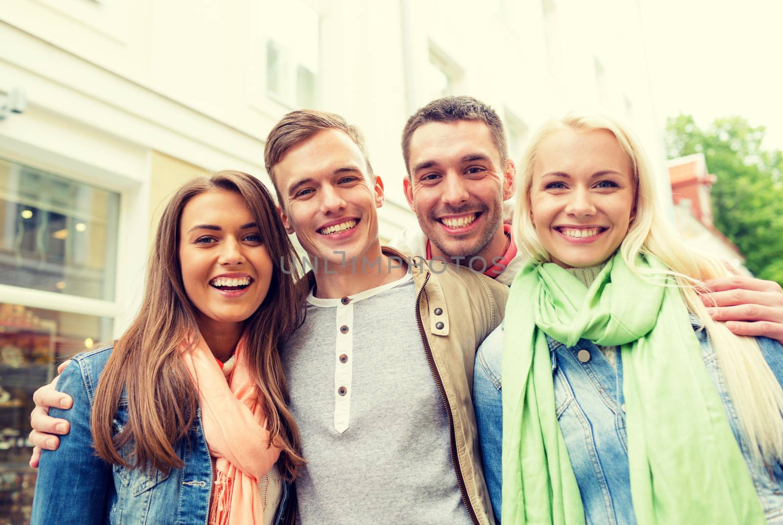 group of smiling friends in city by dolgachov