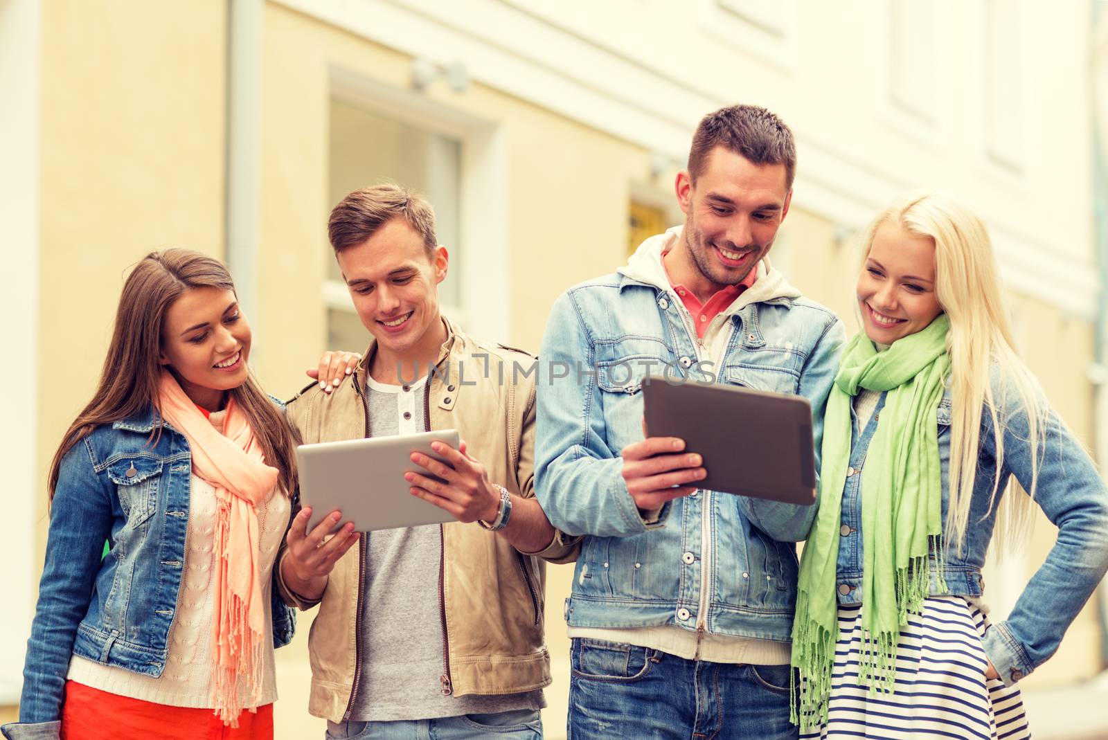 group of smiling friends with tablet pc computers by dolgachov