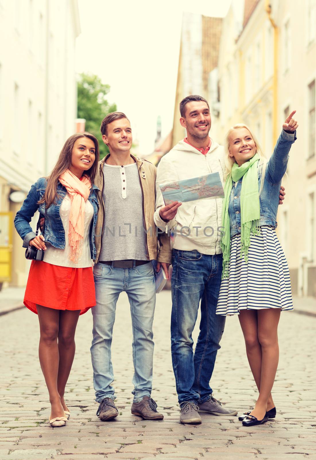 group of smiling friends with map and photocamera by dolgachov