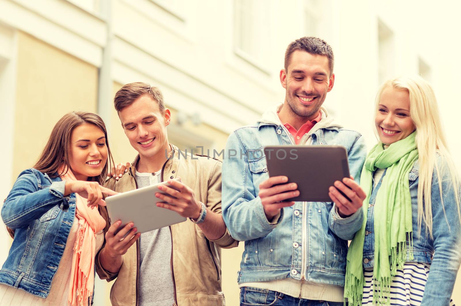 group of smiling friends with tablet pc computers by dolgachov