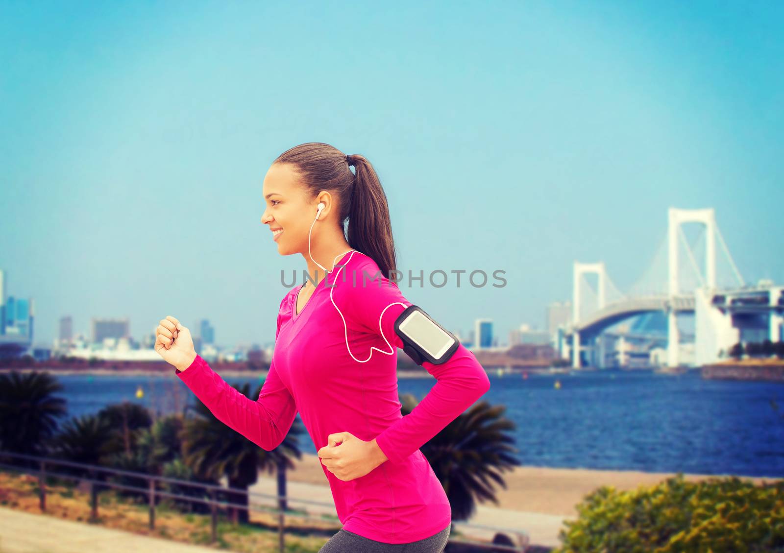 smiling young woman running outdoors by dolgachov