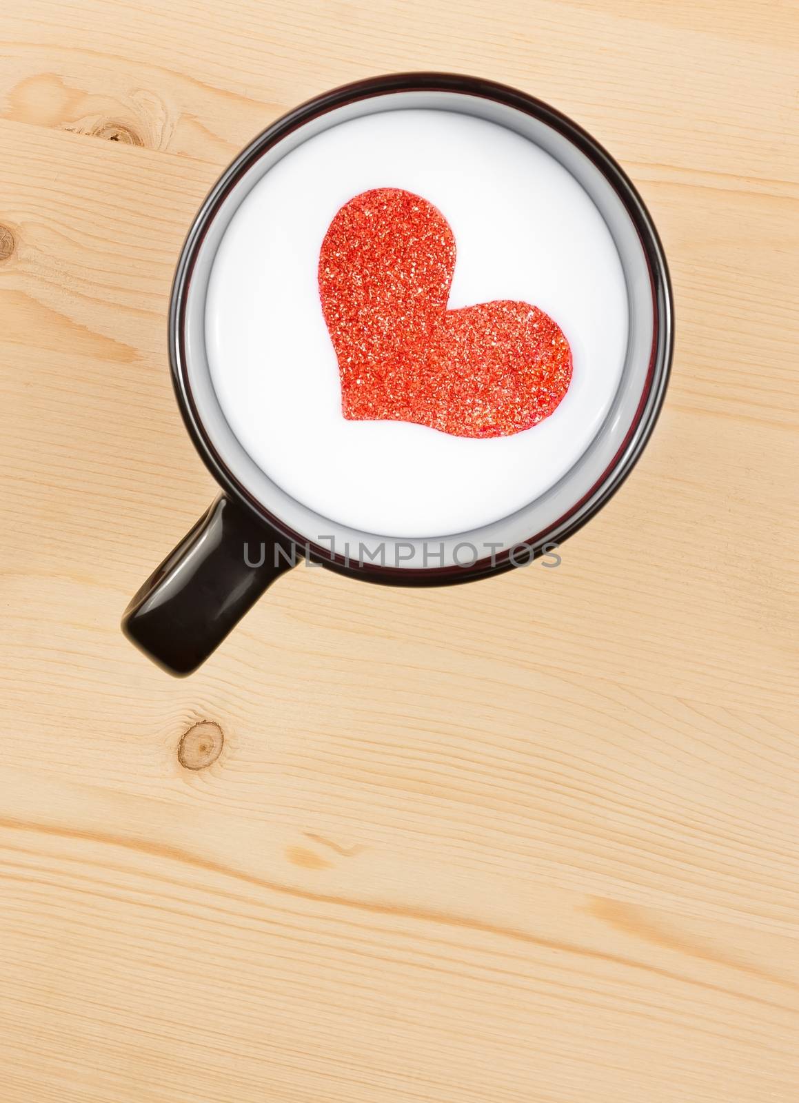 top of view of cup of milk with decorative heart on wood table, concept of valentine day by donfiore