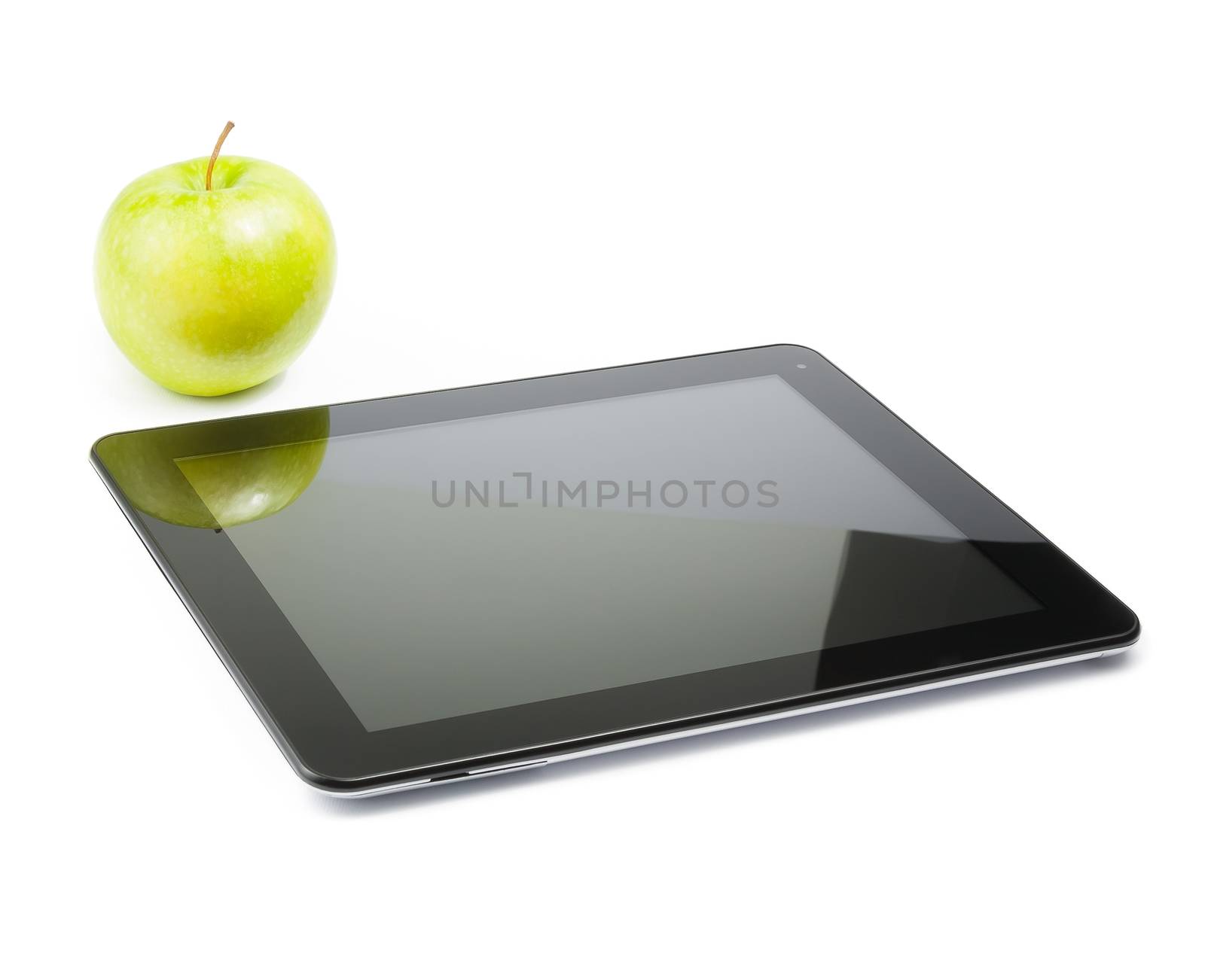 digital tablet pc near green apple on white background by donfiore