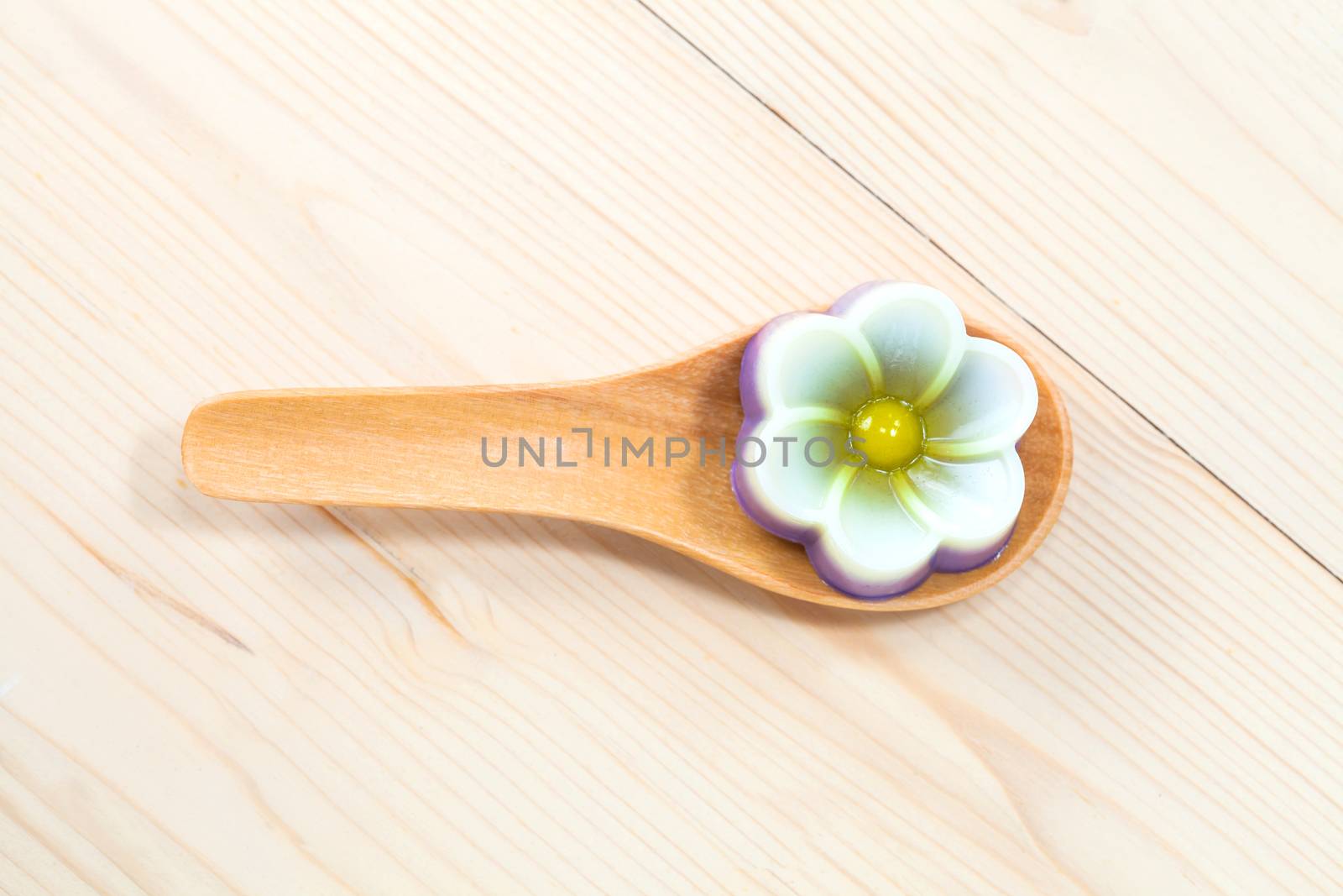 Thailand tradition ,Flower Dessert Coconut Jelly on wood 
spoon 
