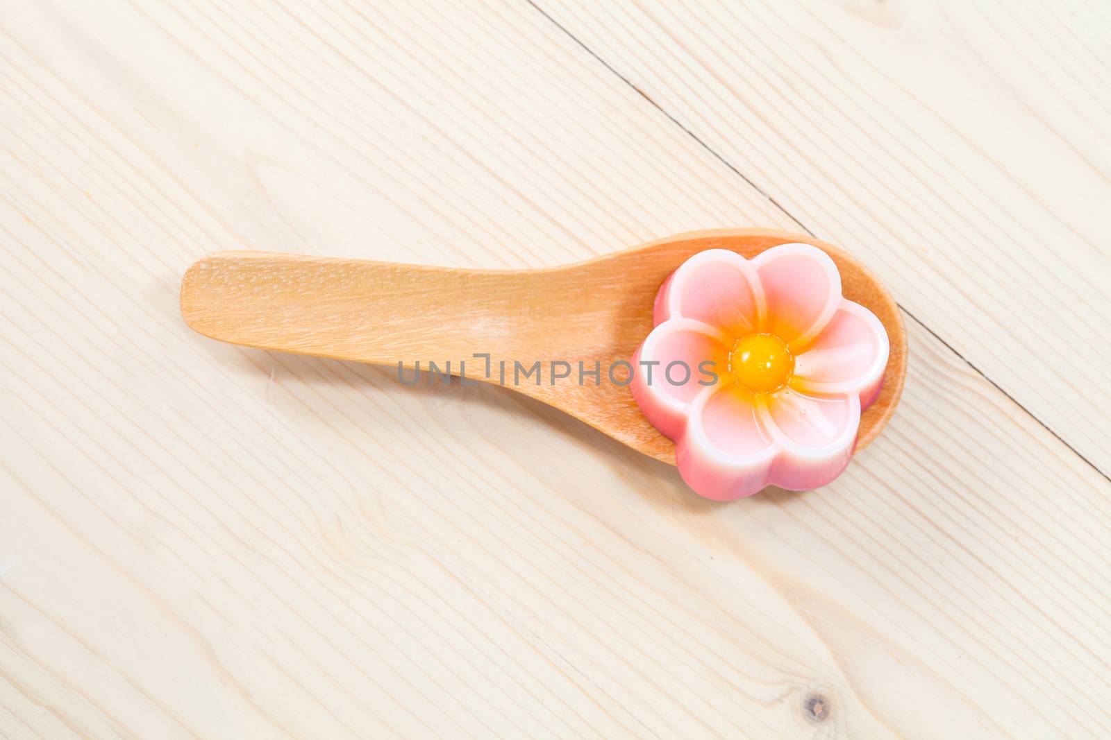 Thailand tradition ,Flower Dessert Coconut Jelly on wood 
spoon 