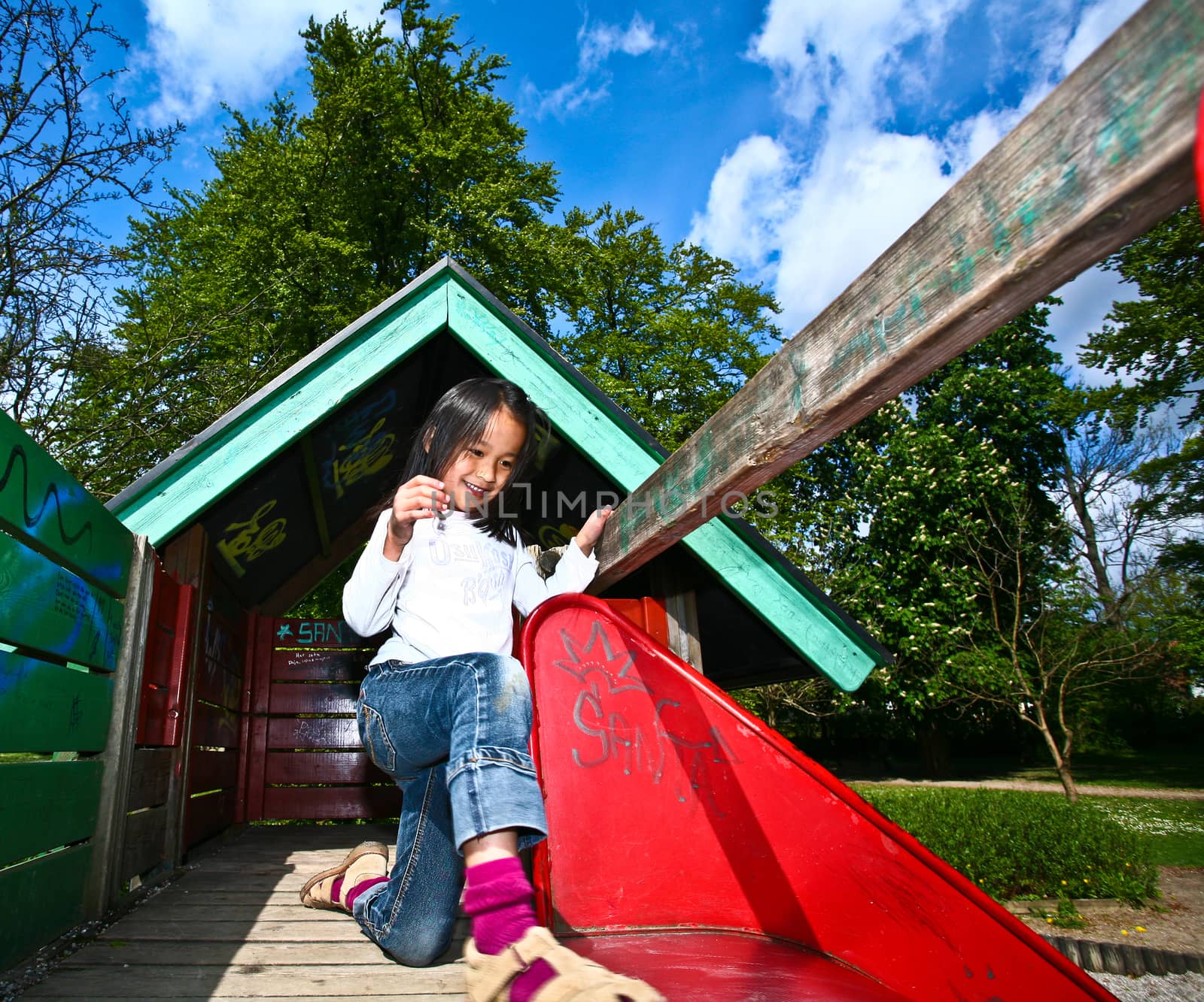 Girl on a playfield in Denmark in the sun