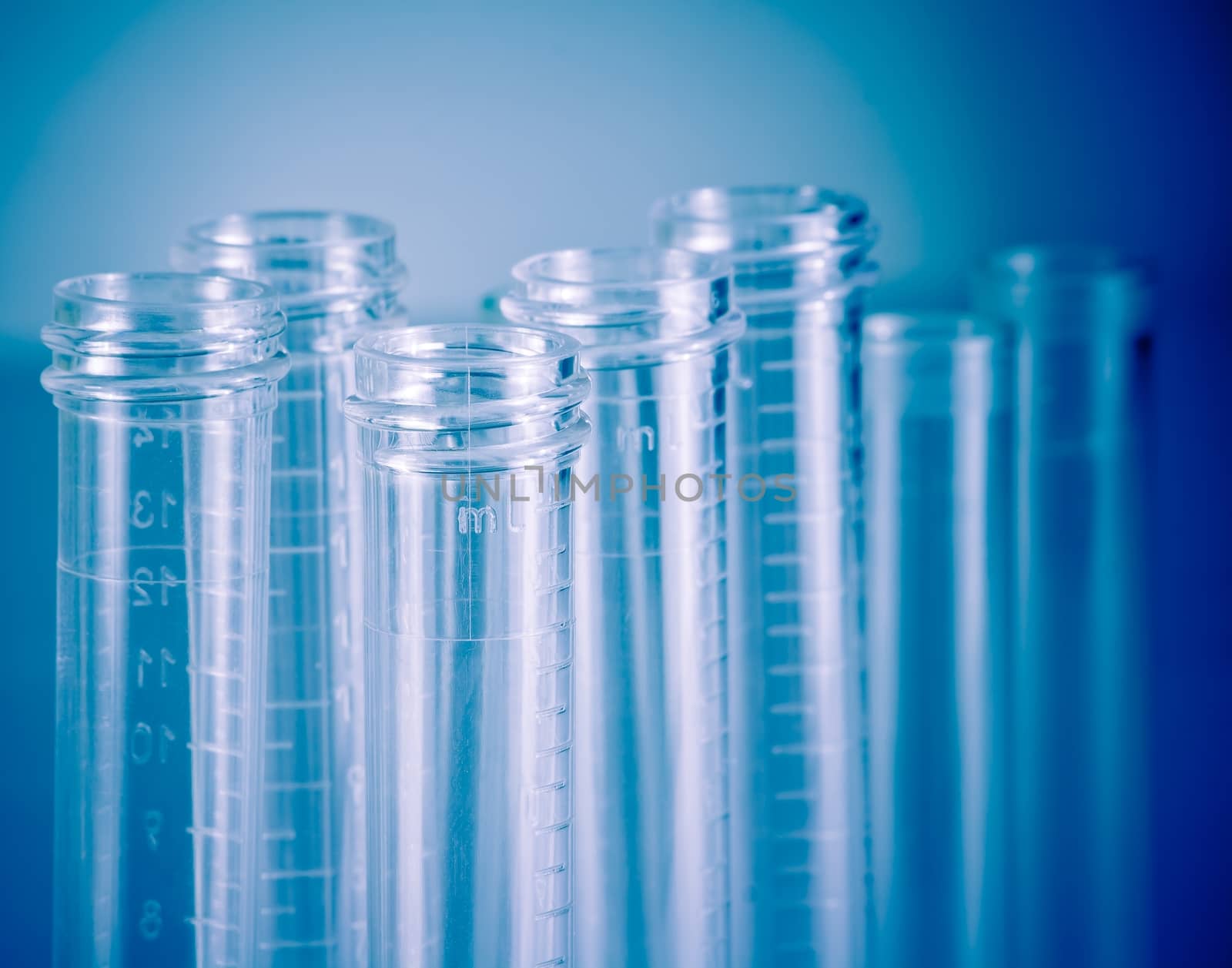 detail of the test tubes in laboratory on blue light tint background