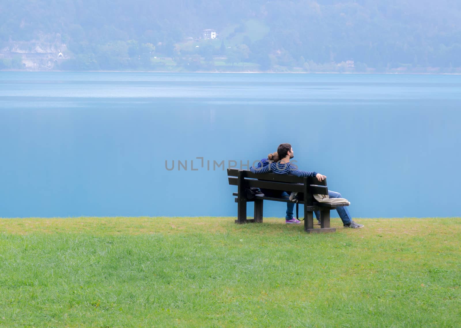 Lovers on a bench on the lake