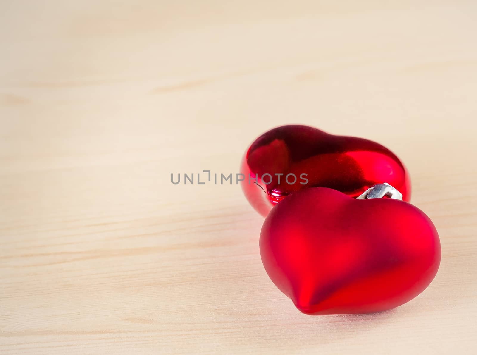 two decorative red hearts on wood background with space for text, concept of valentine day