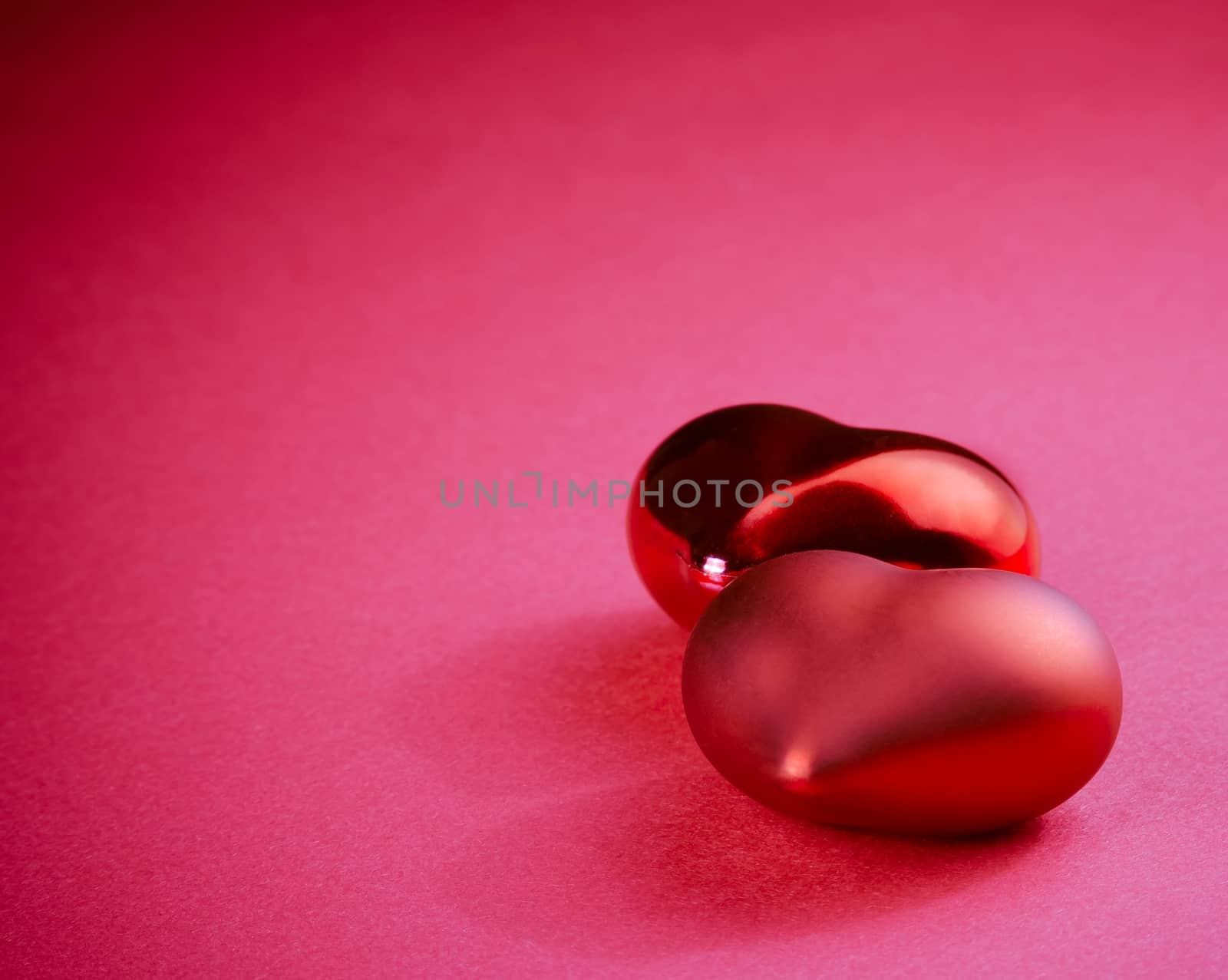 two decorative red hearts on pink background, concept of valentine day by donfiore