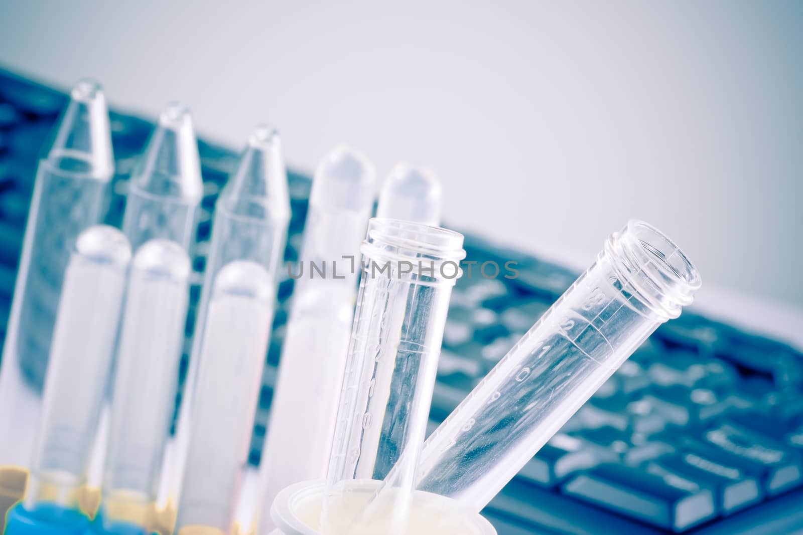 test tubes in laboratory near keyboard on table