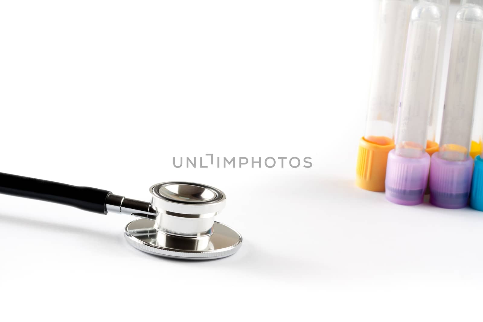 test tubes in laboratory near stethoscope on white background with space for text