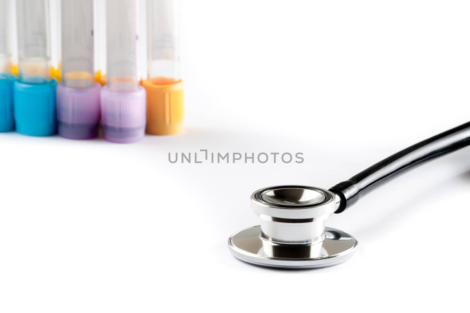 stethoscope in front of the test tubes in laboratory on white background with space for text