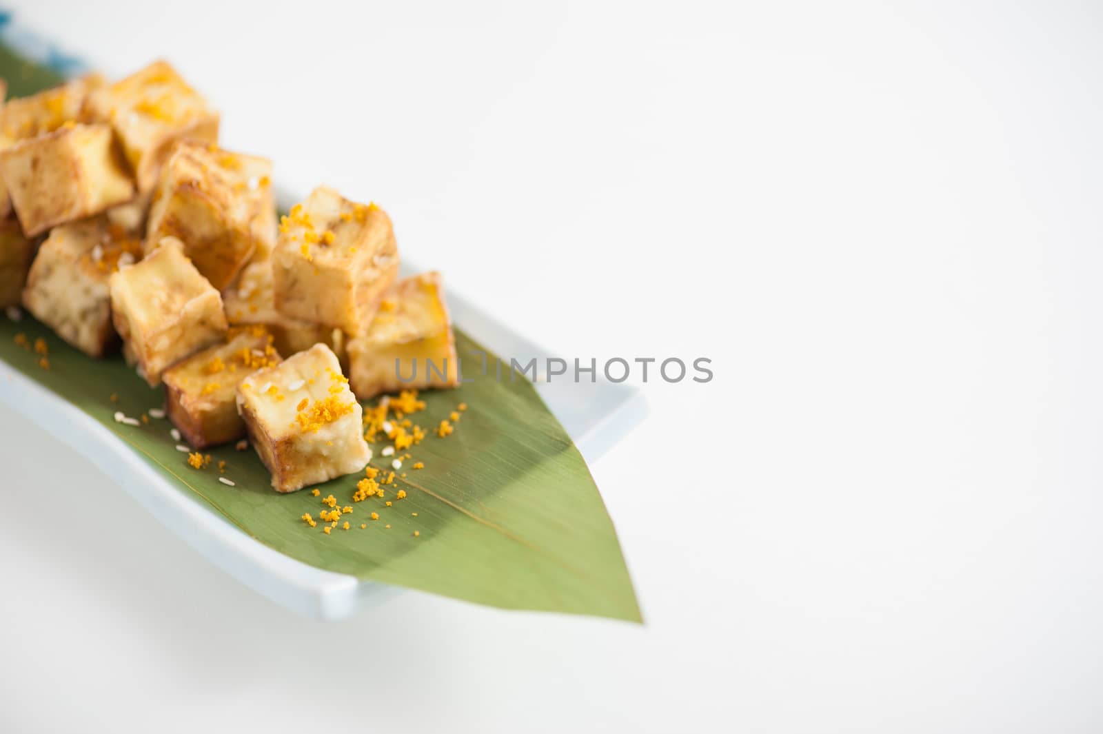 Fake fried tofu (using eggplant replace to tofu) on Japanese bamboo leaf with small cup of plum sauce