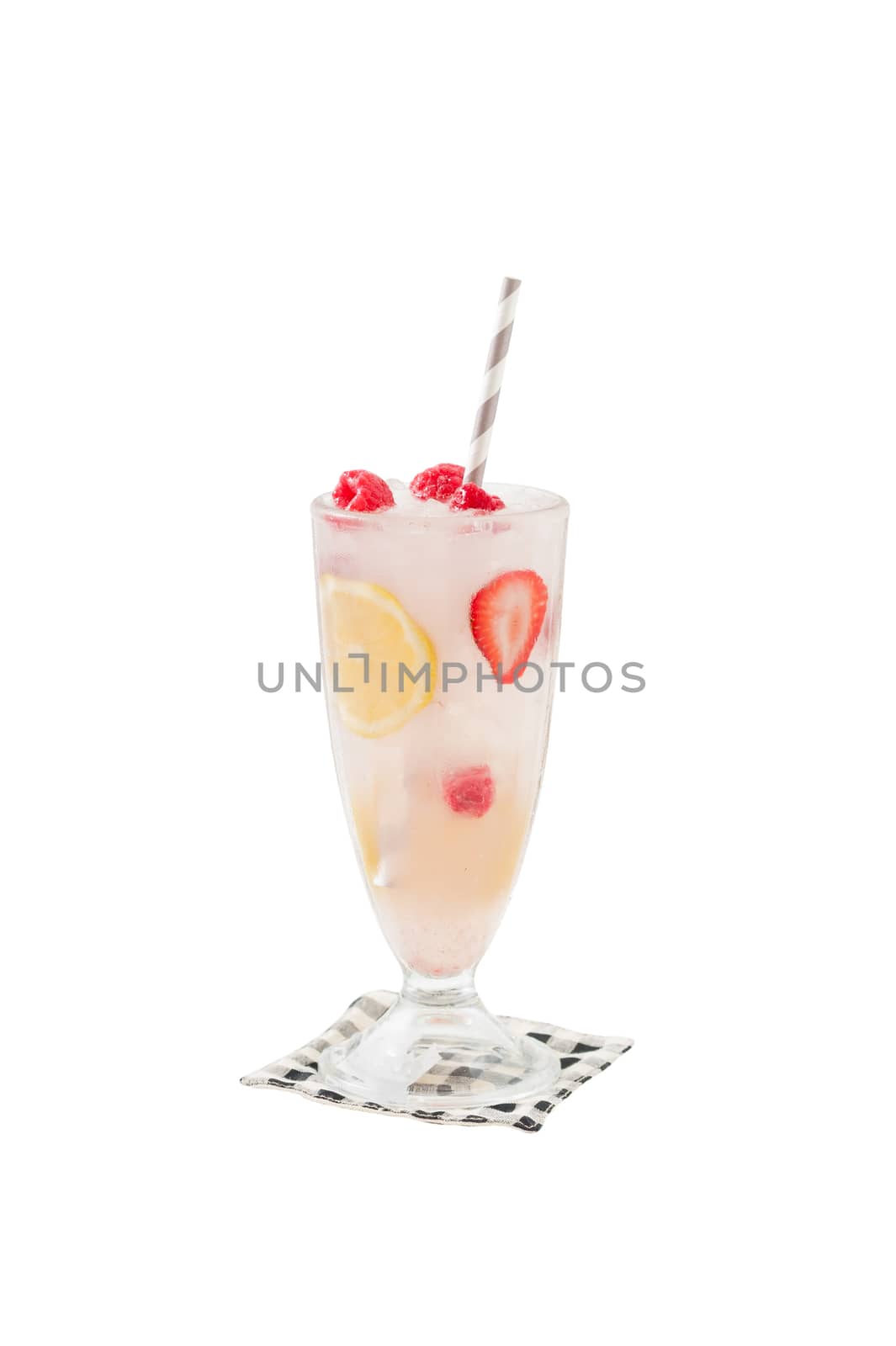 Iced berry lemonade in glass with striped straw garnished with lemon, raspberry and strawberry isolated on white background with clipping path