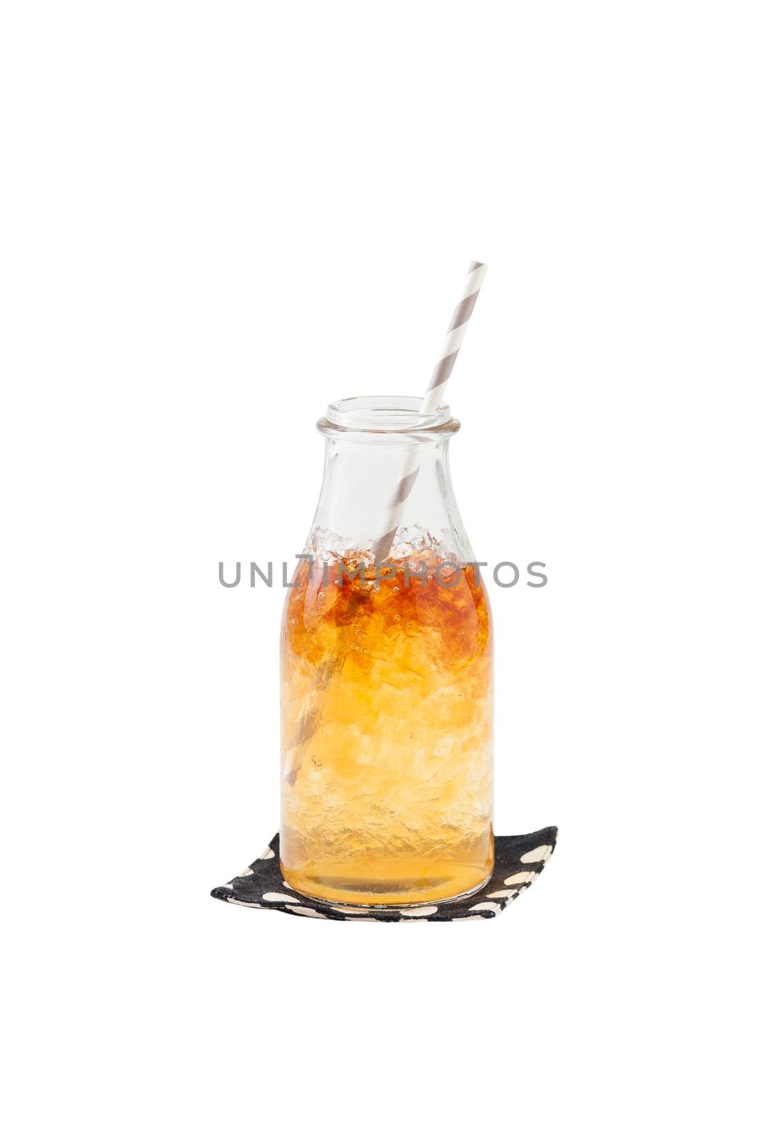 Iced carramel tea in glass bottle with striped straw isolated on white background with clipping path