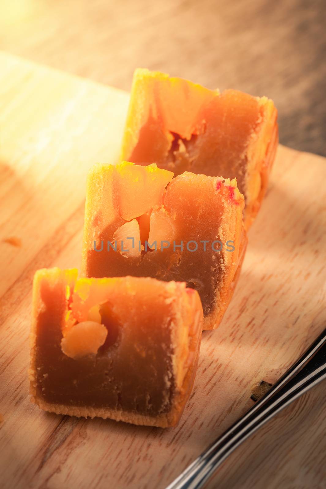 Moon cake, Chinese mid autumn festival dessert on wood board with dramatic morning scene