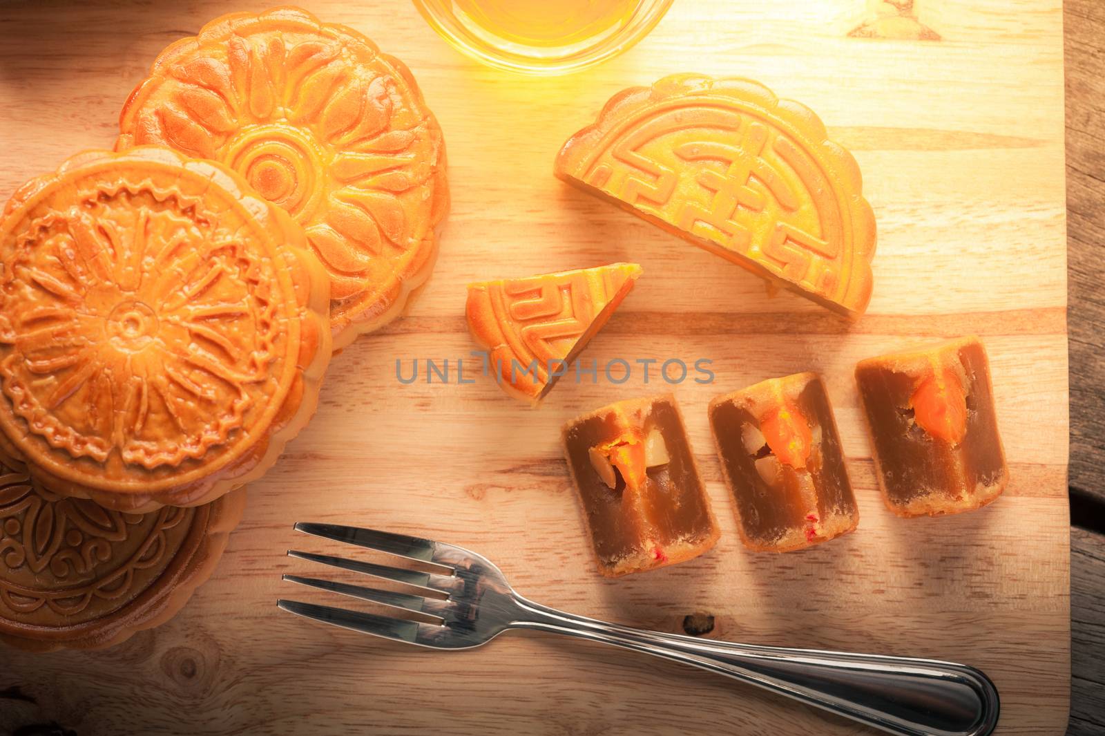 Moon cake, Chinese mid autumn festival dessert on wood board with dramatic morning scene