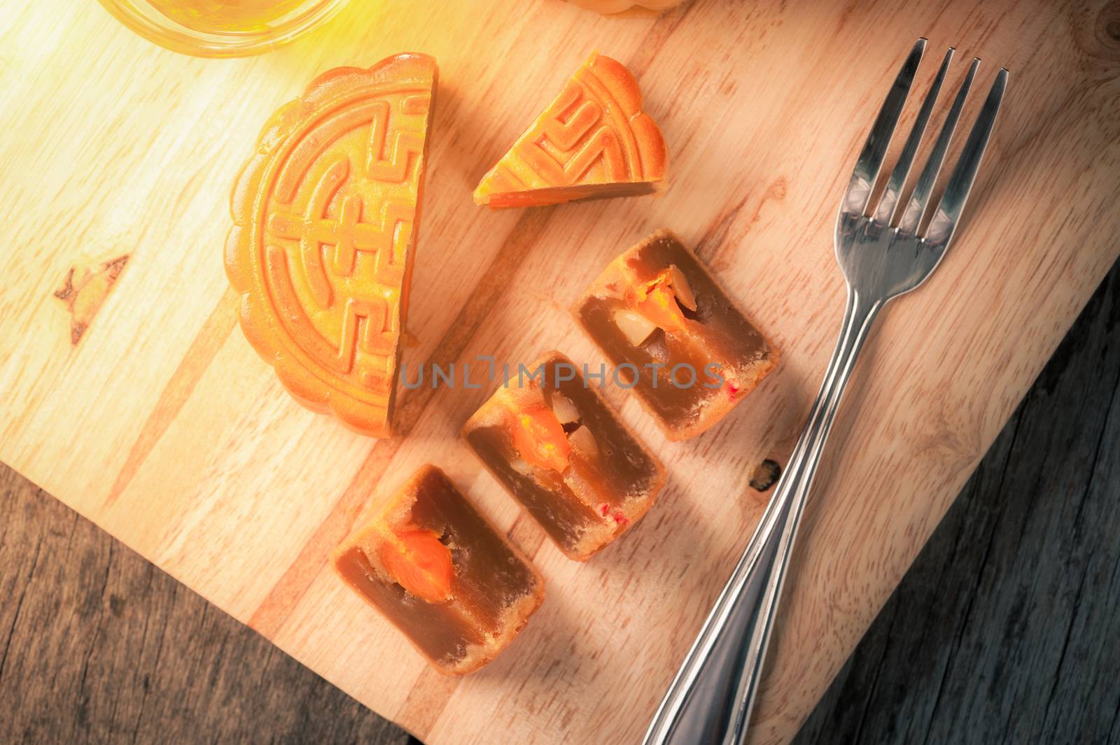 Moon cake, Chinese mid autumn festival dessert on wood board with dramatic morning scene