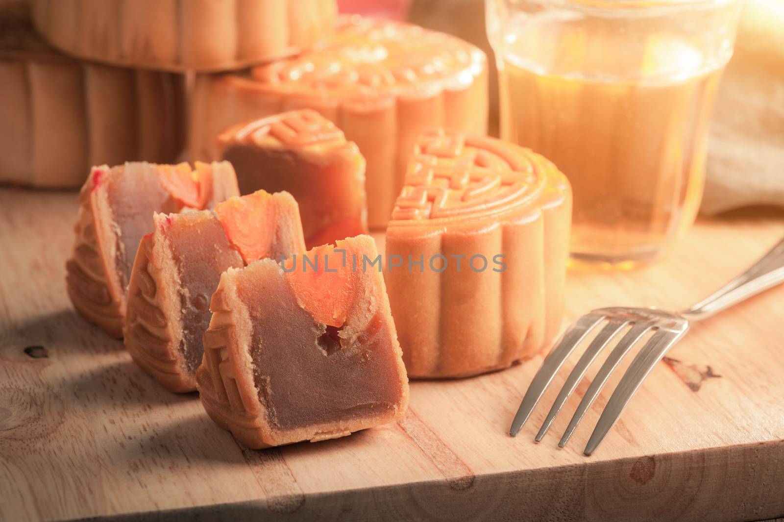 Moon cake, Chinese mid autumn festival dessert on wood board with dramatic morning scene