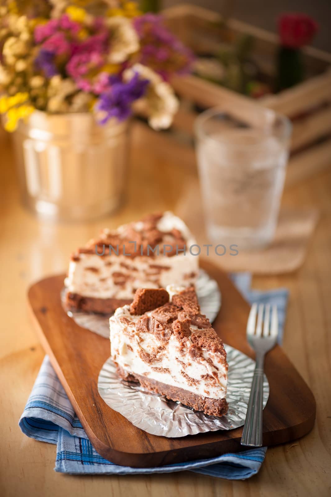 Chocolate cookie cheese cake on wood table with vintage scene in morning