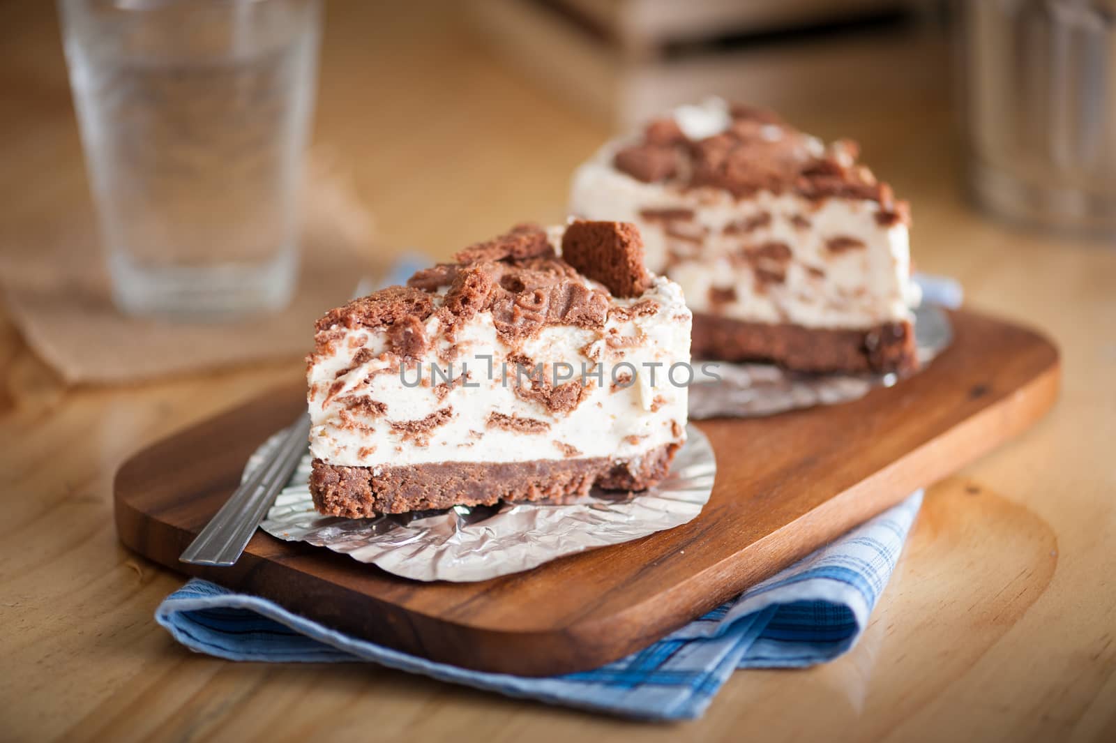Chocolate cookie cheese cake on wood table with vintage scene in morning