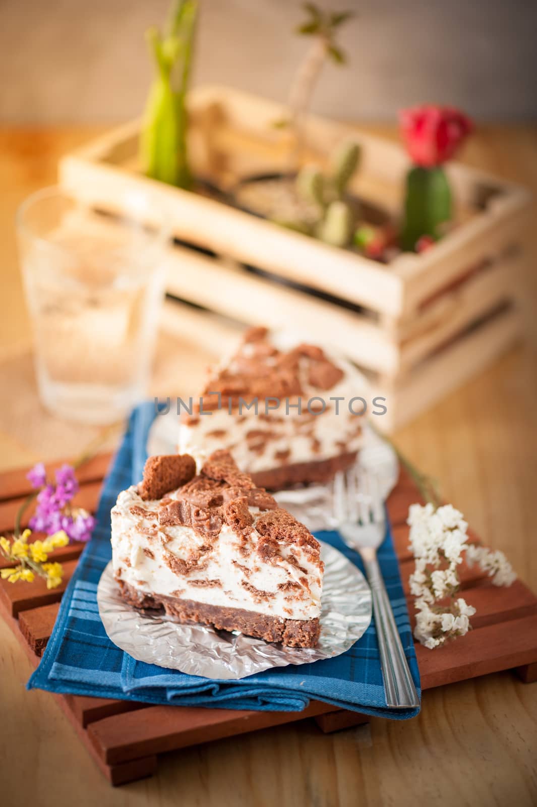 Chocolate cookie cheese cake on wood table with vintage scene in morning