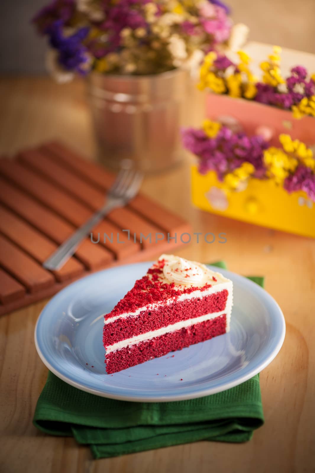 Red velvet cake on wood table with morning scene
