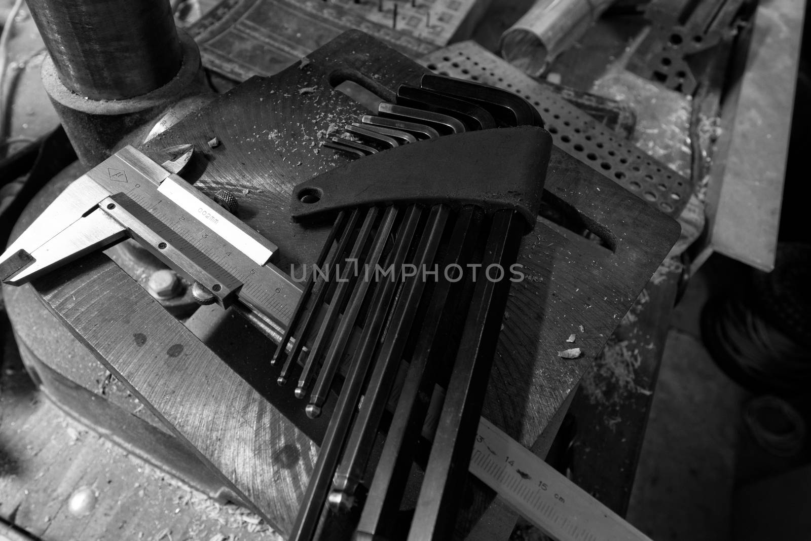 Set of tools over a wood panel on black and white