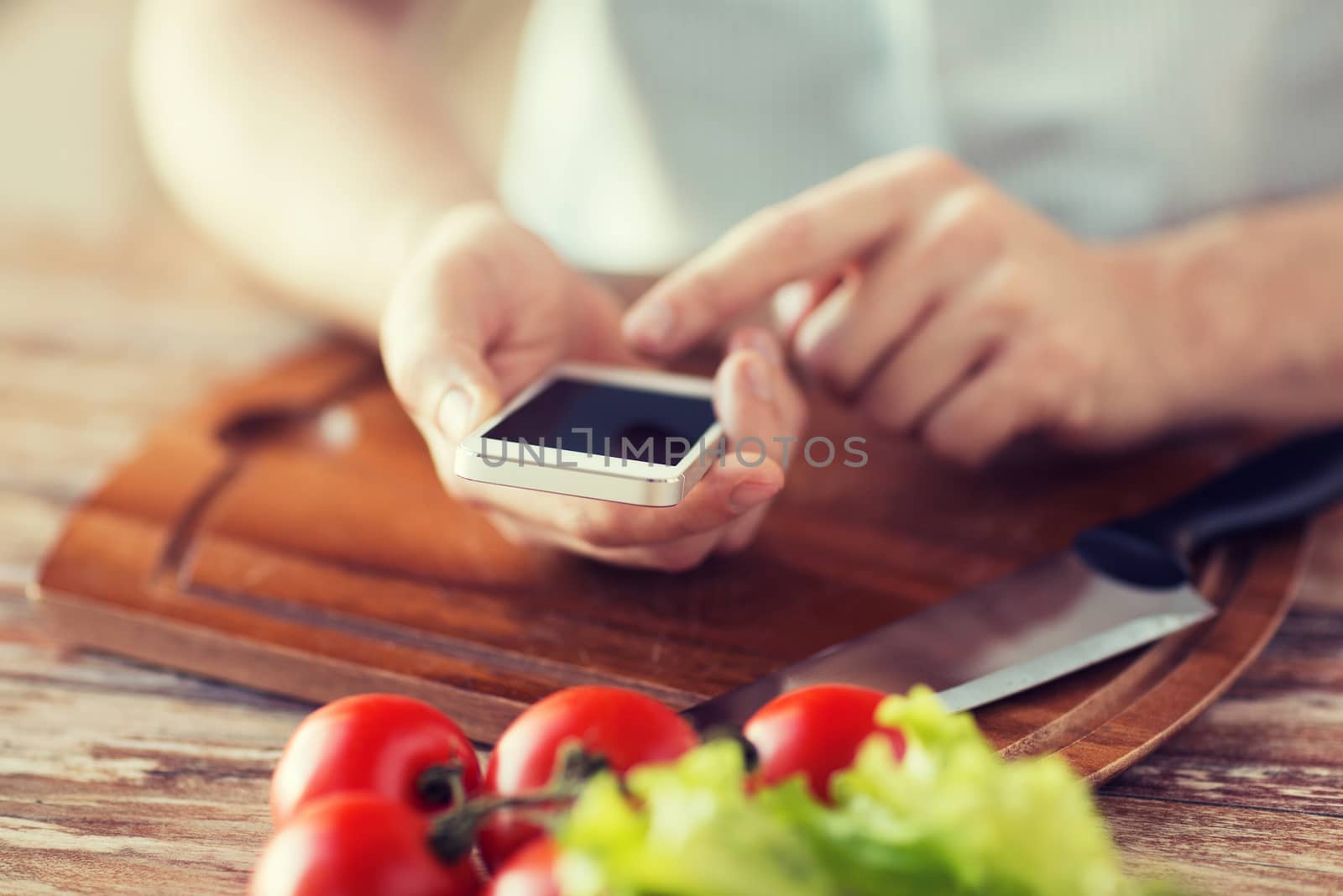 closeup of man pointing finger to smartphone by dolgachov