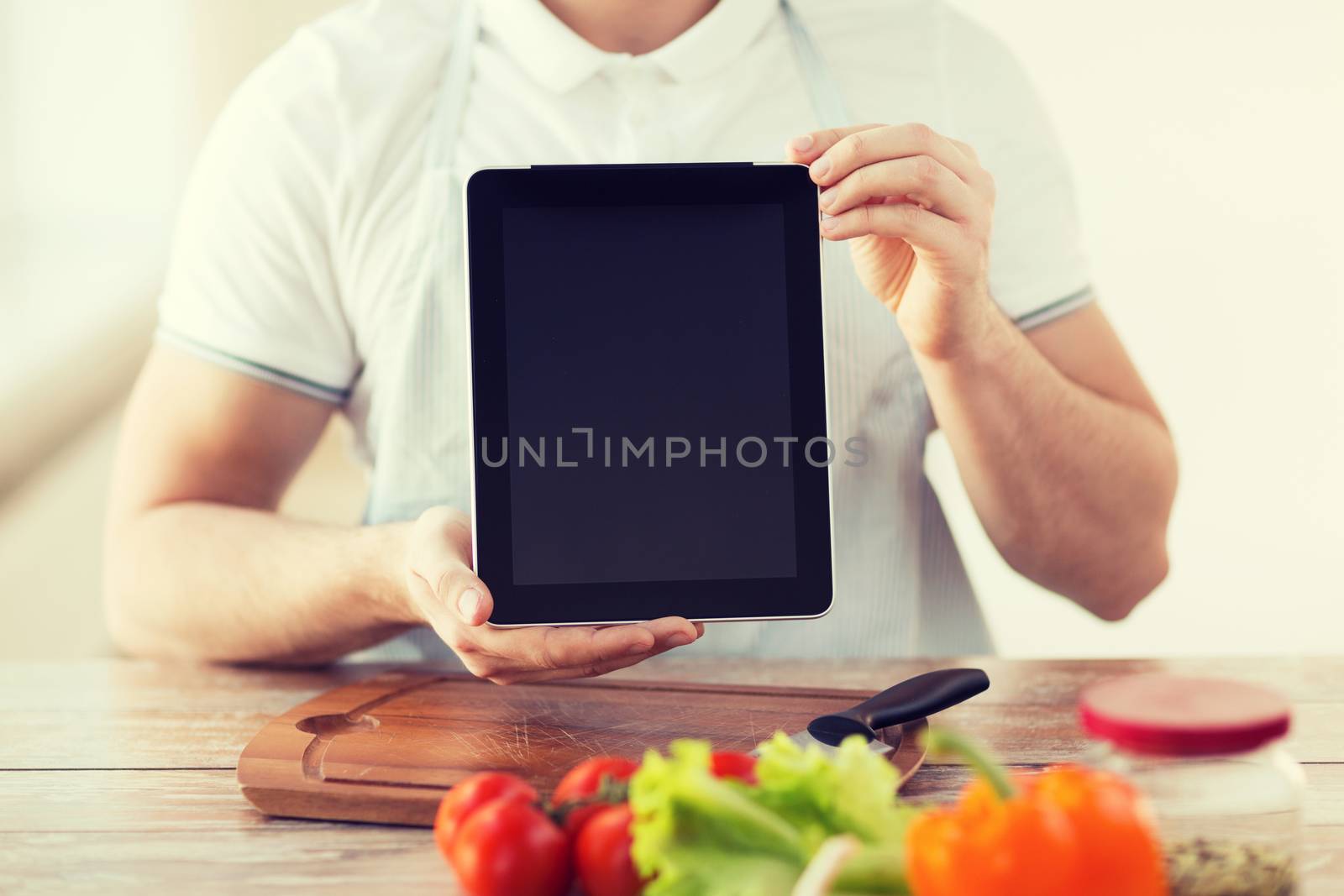 close up of male hands holding tablet pc by dolgachov