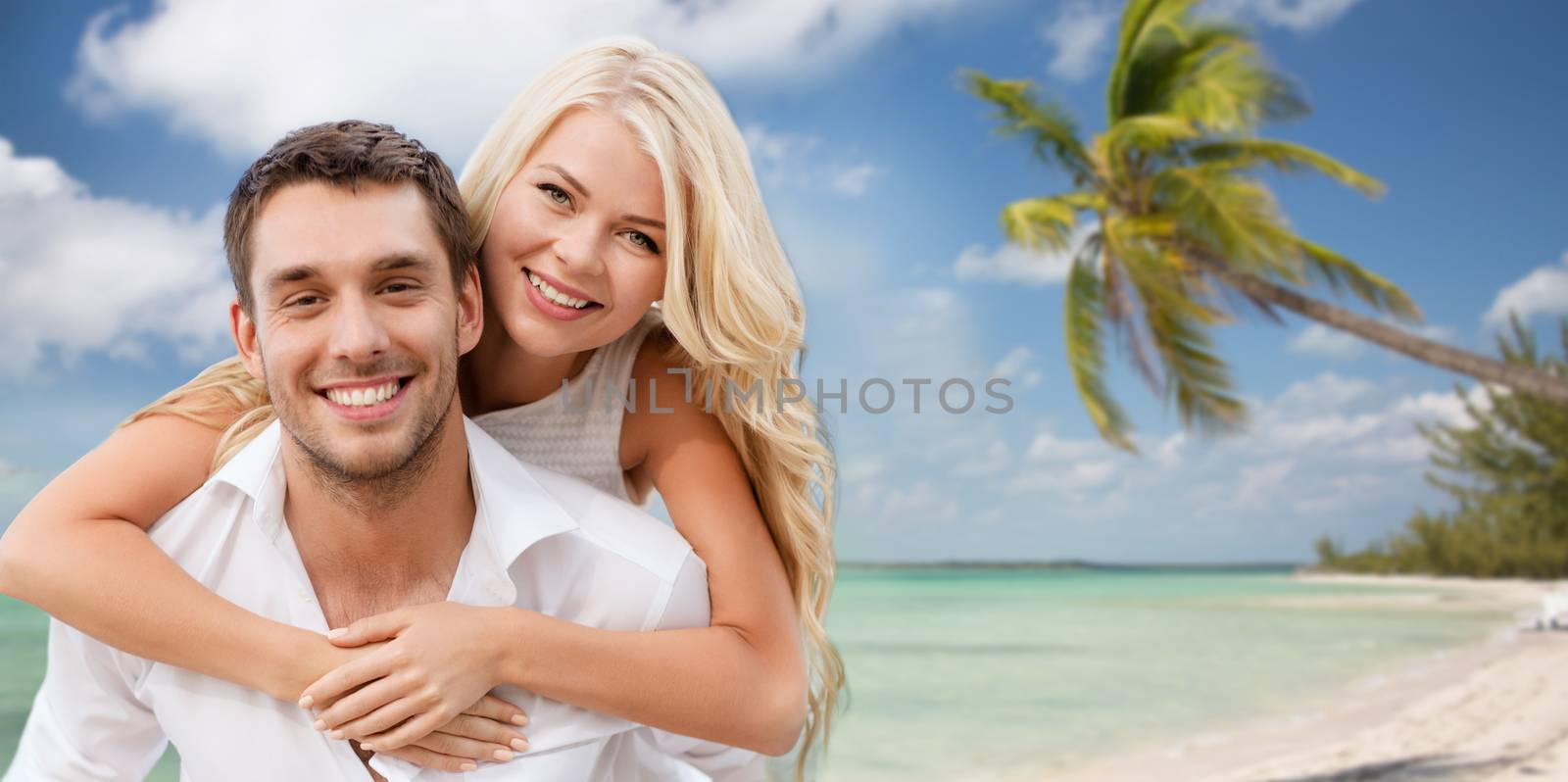 happy couple having fun over beach background by dolgachov
