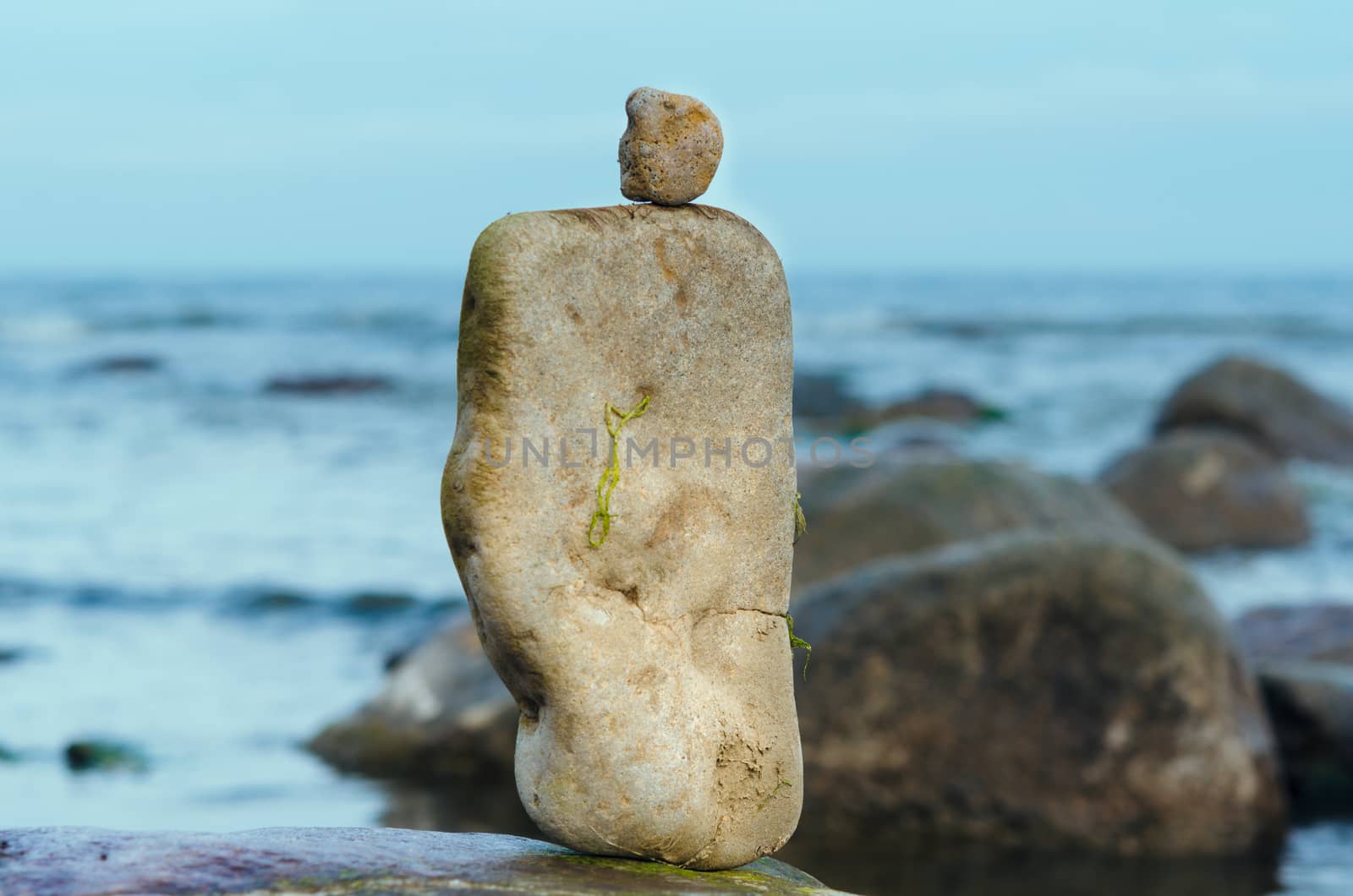 Pebbles between of the boulders on the seashore