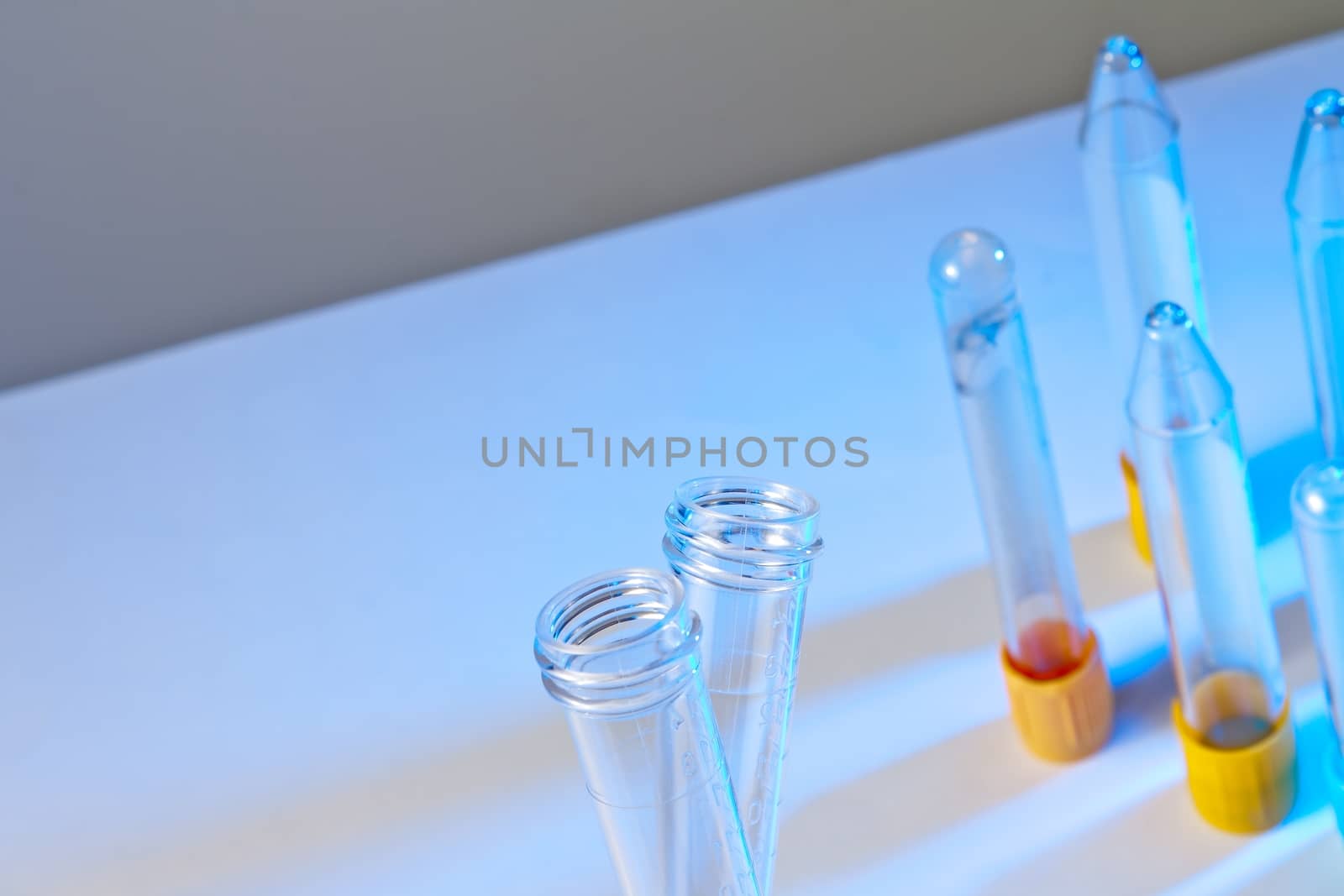 detail of the test tubes in front of test tubes on table in laboratory on blue background