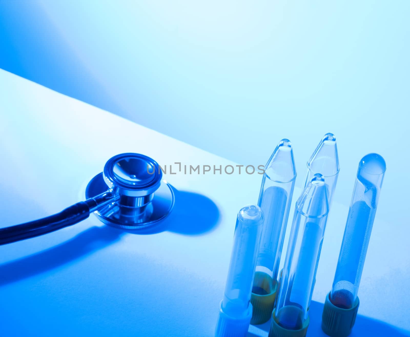 test tubes in laboratory near stethoscope on blue light tint background