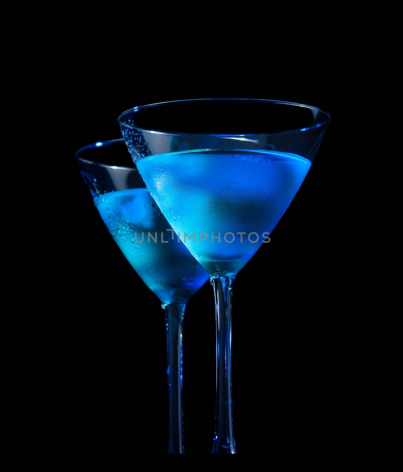 glasses of  fresh cocktail with ice on bar table on black background by donfiore